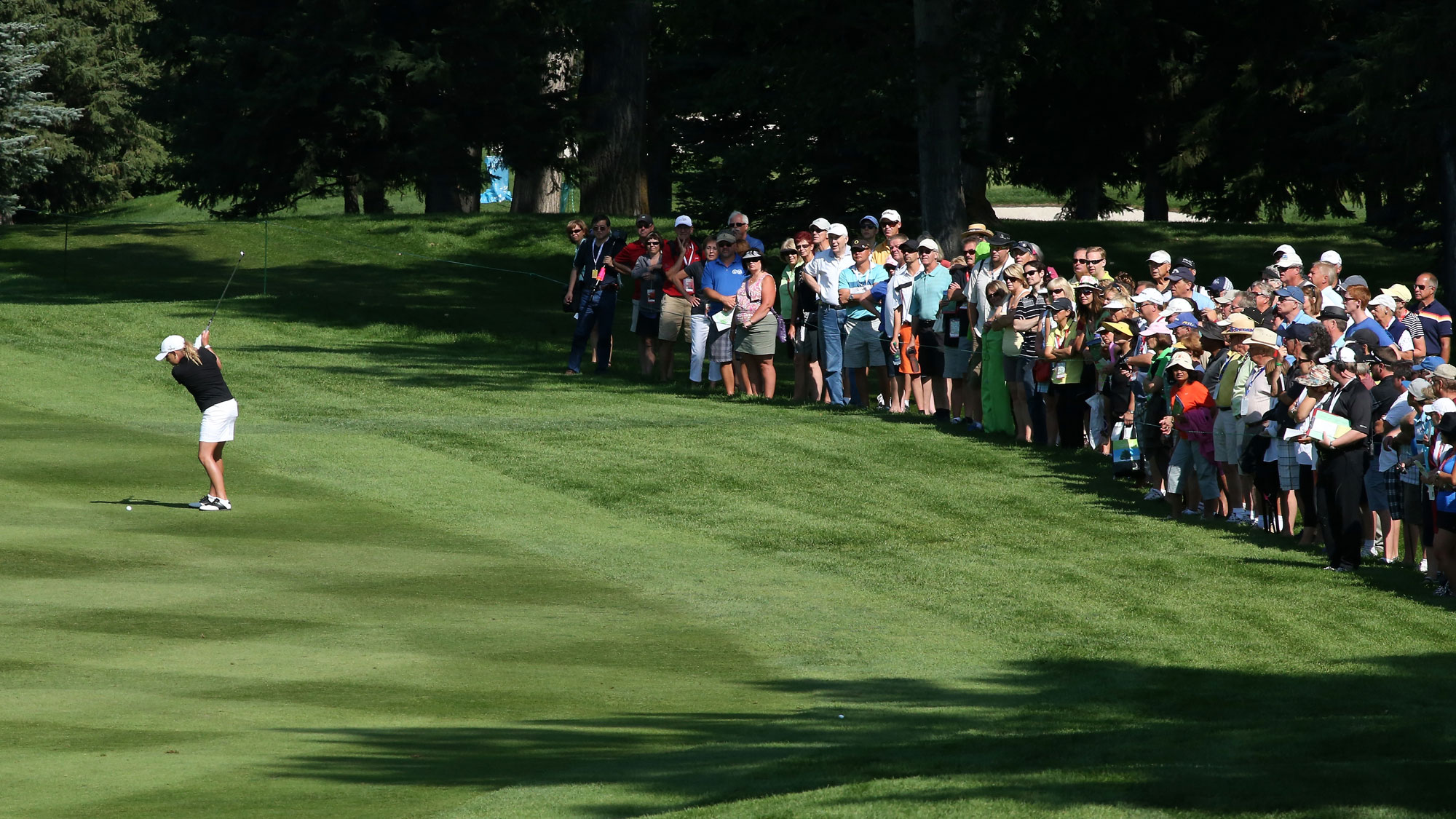 Cristie Kerr hits from the second fairway as the gallery watches during the third round of the CN Canadian Women's Open at Royal Mayfair Golf Club on August 24, 2013 in Edmonton, Alberta, Canada.
