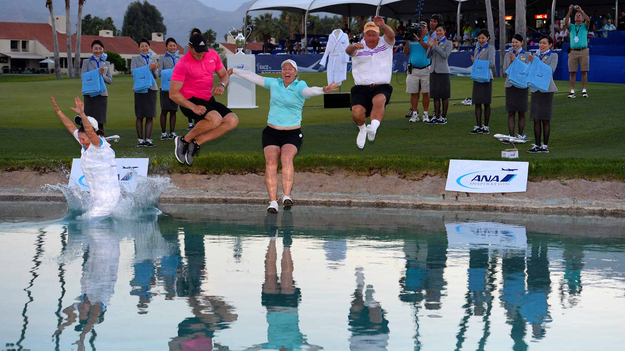 Brittany Lincicome jumps in the water with from left to right, her caddie Missy Pederson, her fiance Dewald Gouws and her father Tom Lincicome after winning the ANA Inspiration