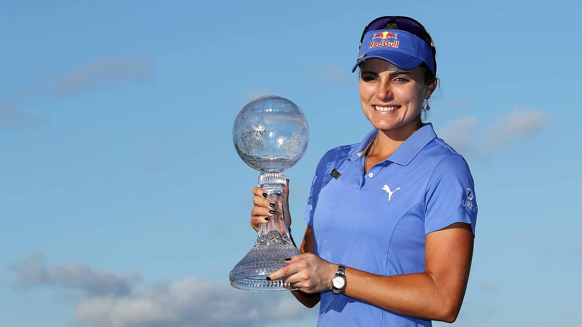 Lexi Thompson of the United States poses with the CME Race for the Globe trophy after the final round of the CME Group Tour Championship