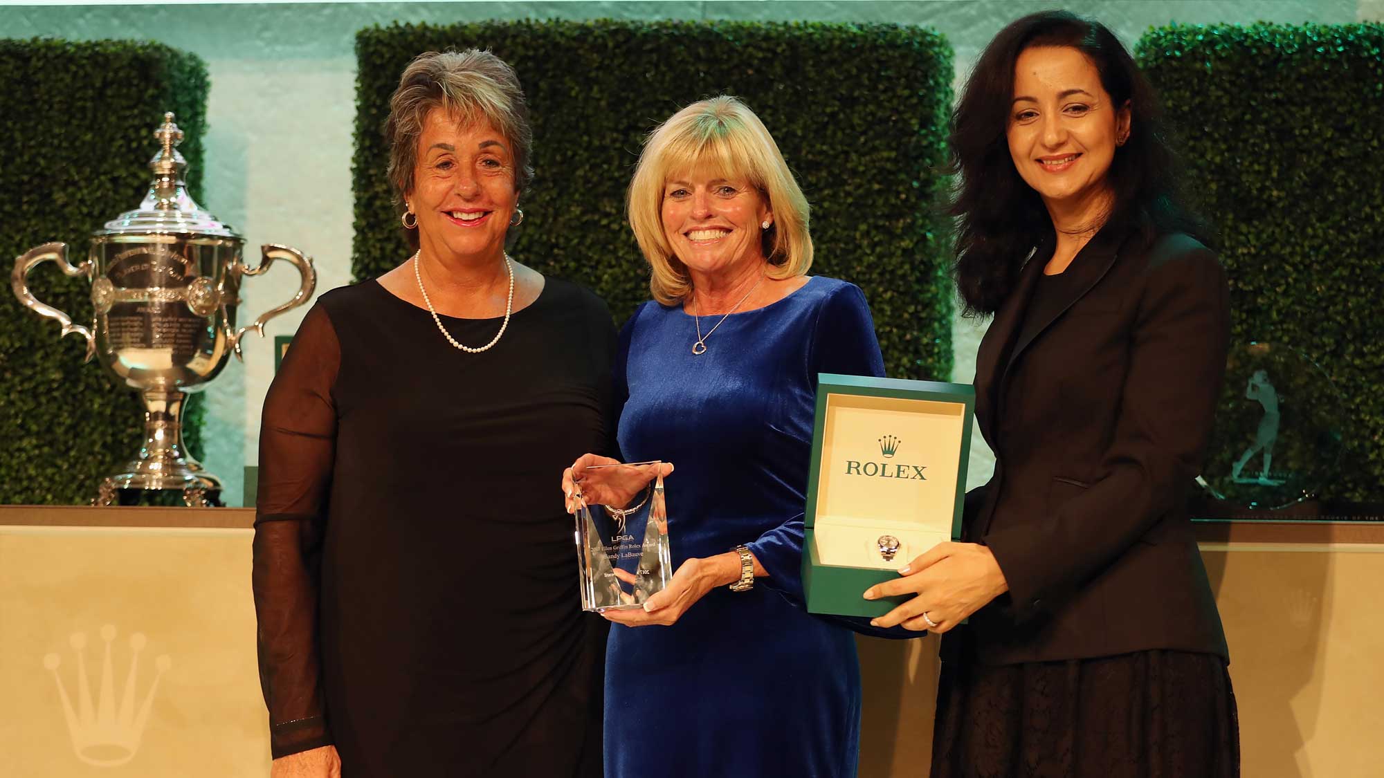 Sandy LaBauve (C) poses after receiving the Ellen Griffin Rolex Award during the LPGA Rolex Players Awards at The Ritz-Carlton Golf Resort