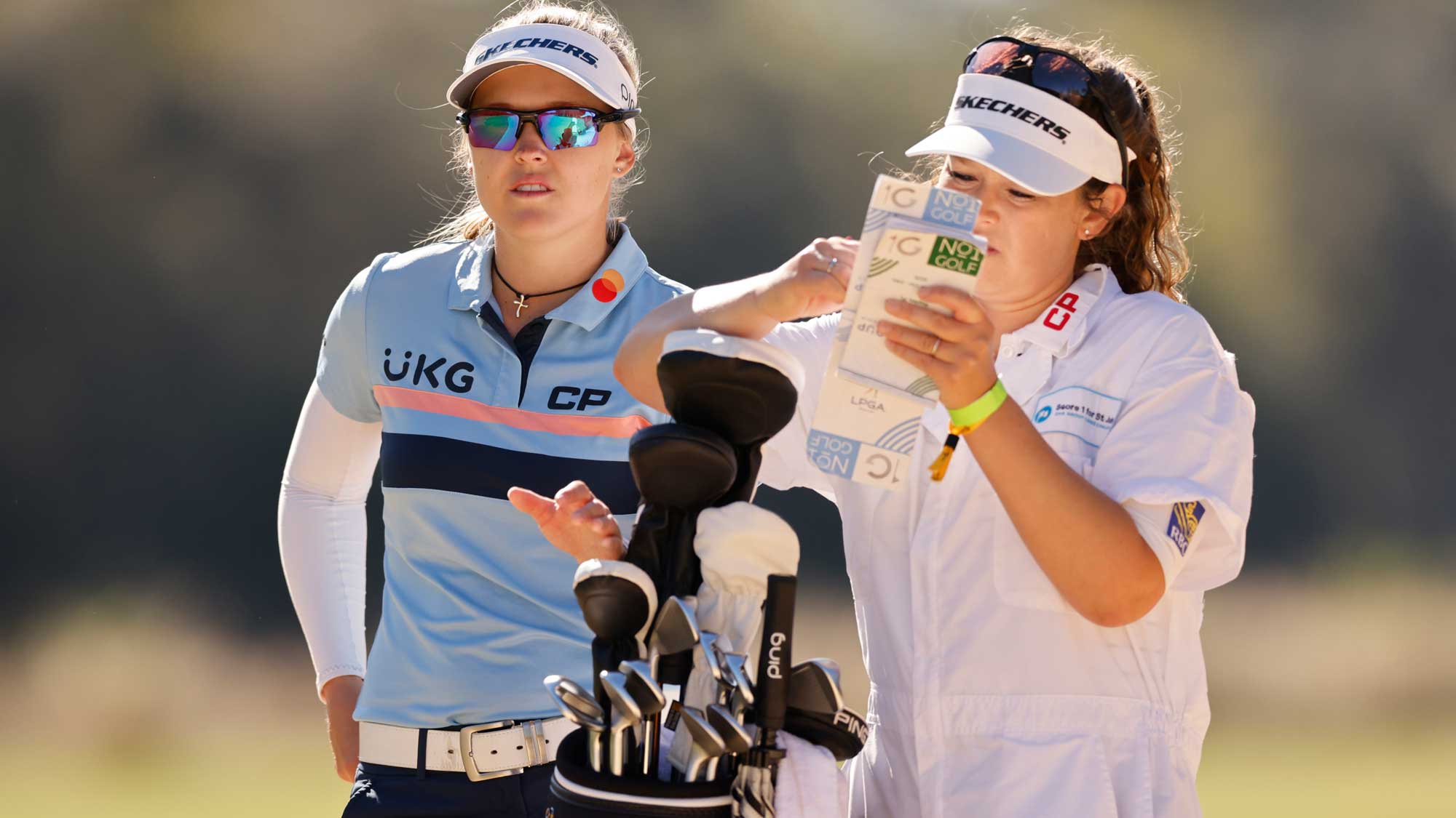 Brooke Henderson of Canada talks with her caddie, Brittany Henderson, on the third hole during the third round of the CME Group Tour Championship
