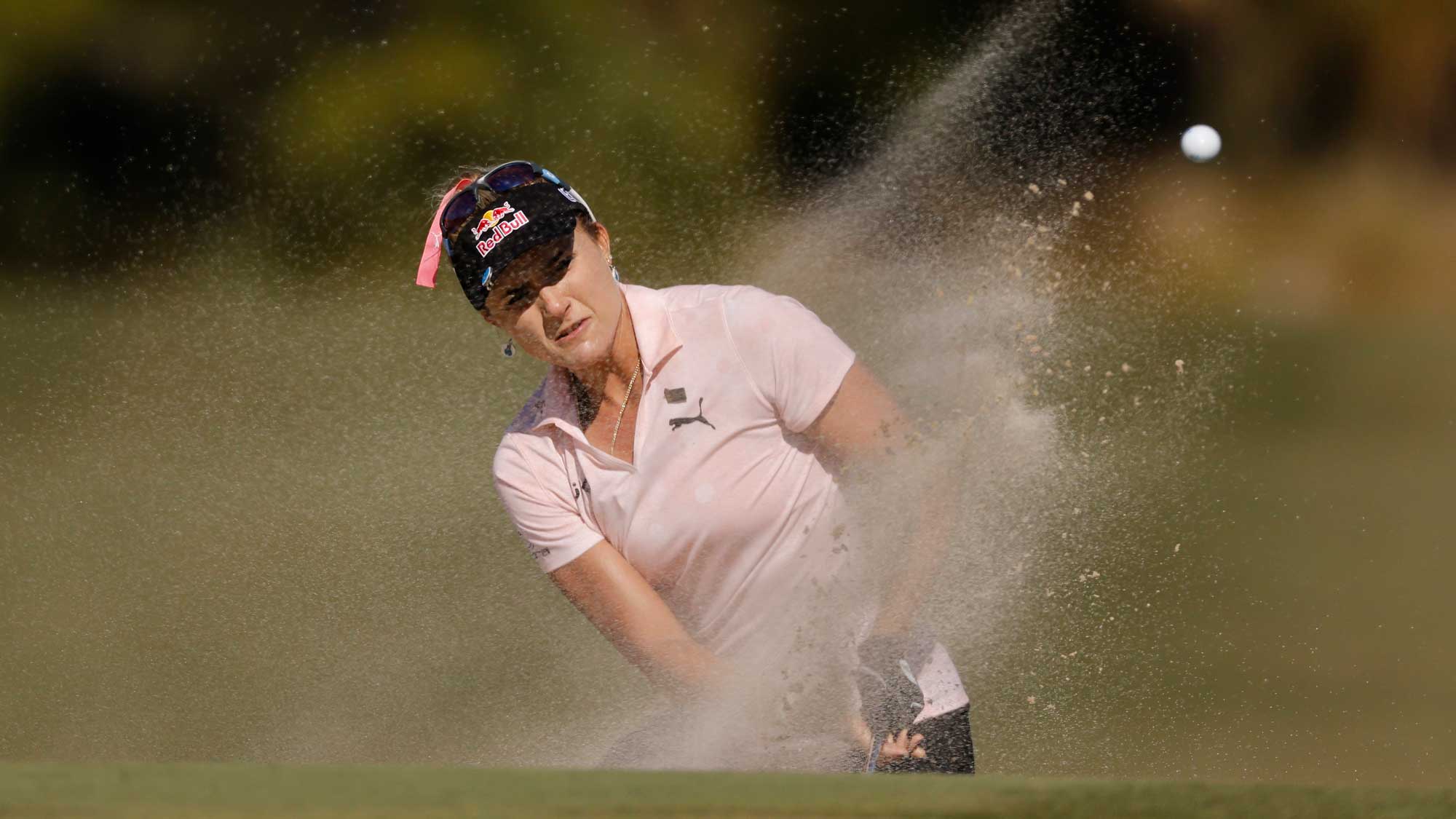 Lexi Thompson of the United States plays a shot from a bunker on the ninth hole during the third round of the CME Group Tour Championship