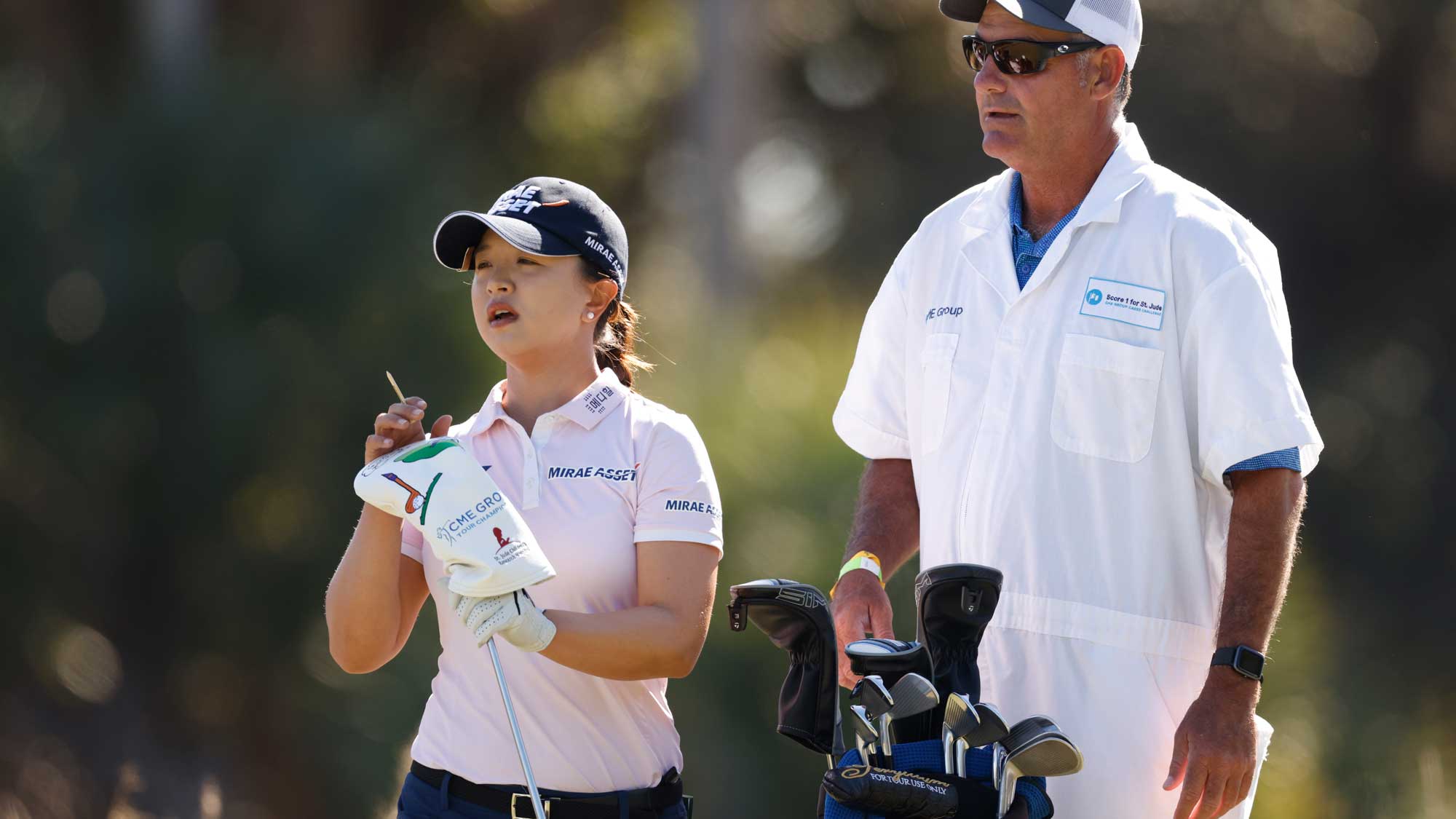 Sei-Young Kim of Korea talks with her caddie on the third hole during the third round of the CME Group Tour Championship