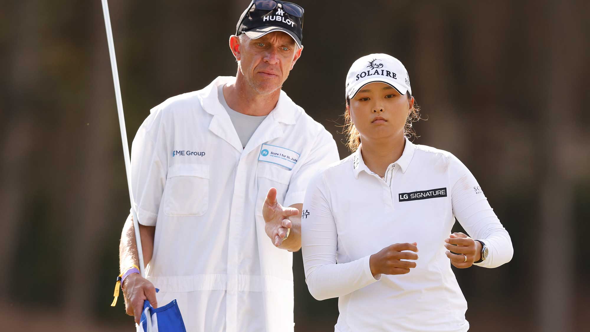 Jin Young Ko of Korea talks with her caddie, David Brooker, on the third hole during the final round of the CME Group Tour Championship