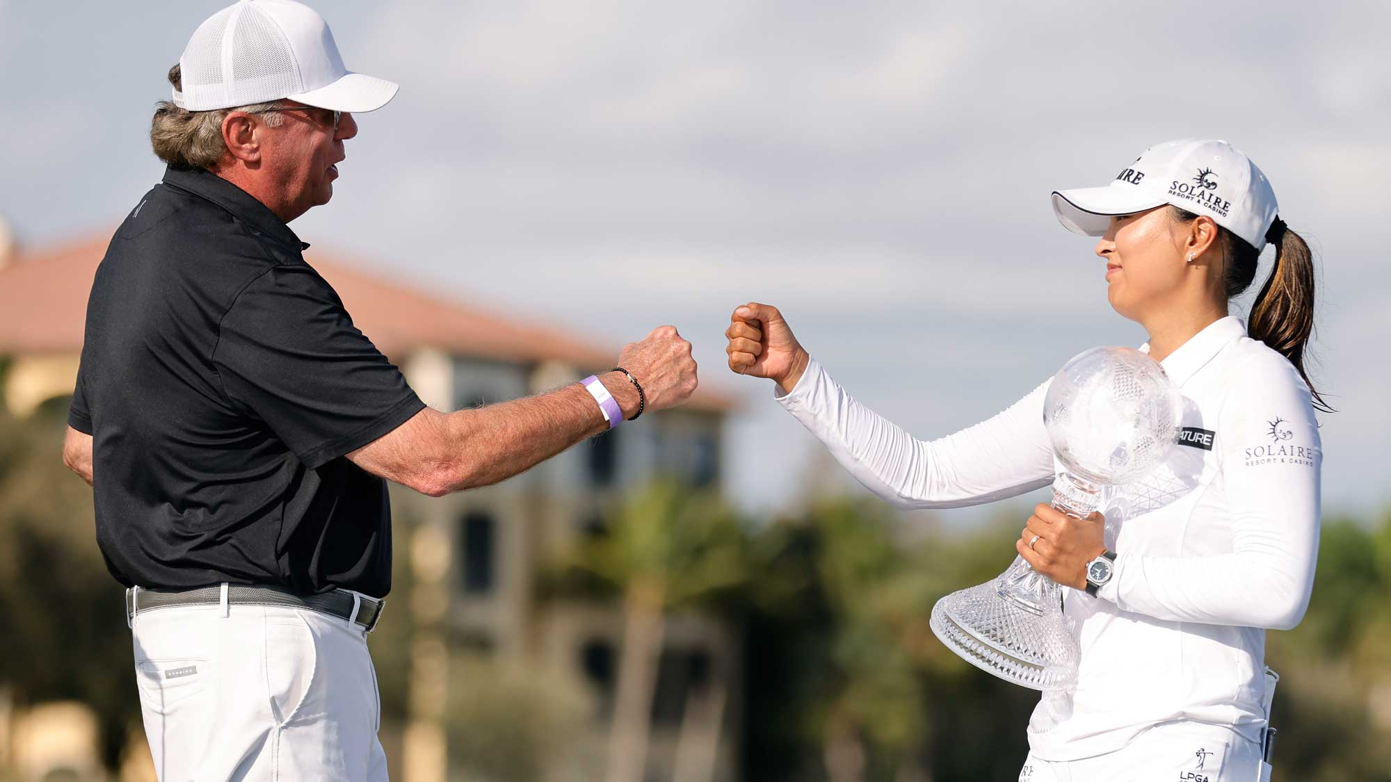 CME Group CEO Terry Duffy (L) fist bumps Jin Young Ko of Korea after she won the CME Group Tour Championship