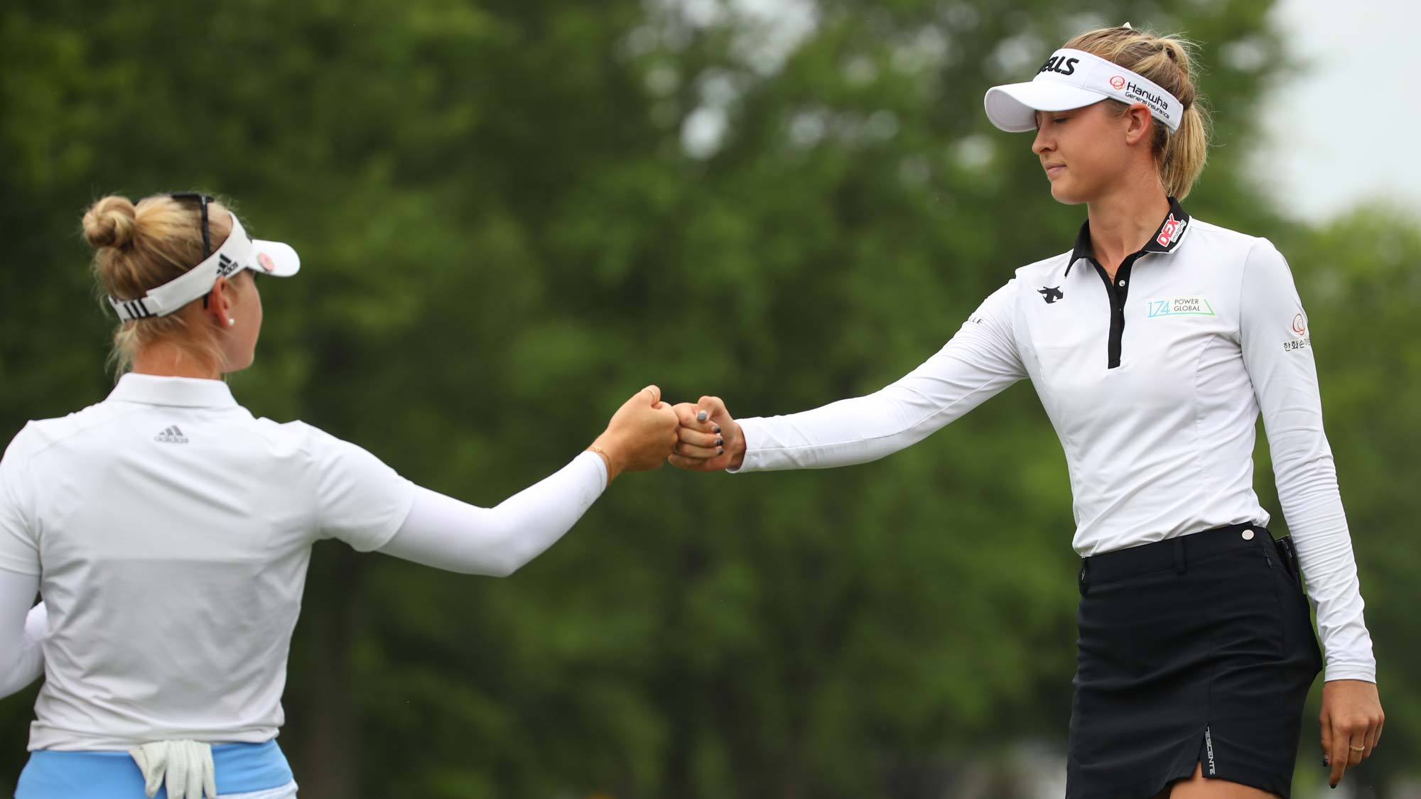 Teammates Jessica Korda (L) and Nelly Korda celebrate on the first green during round two of the Dow Great Lakes Bay Invitational 