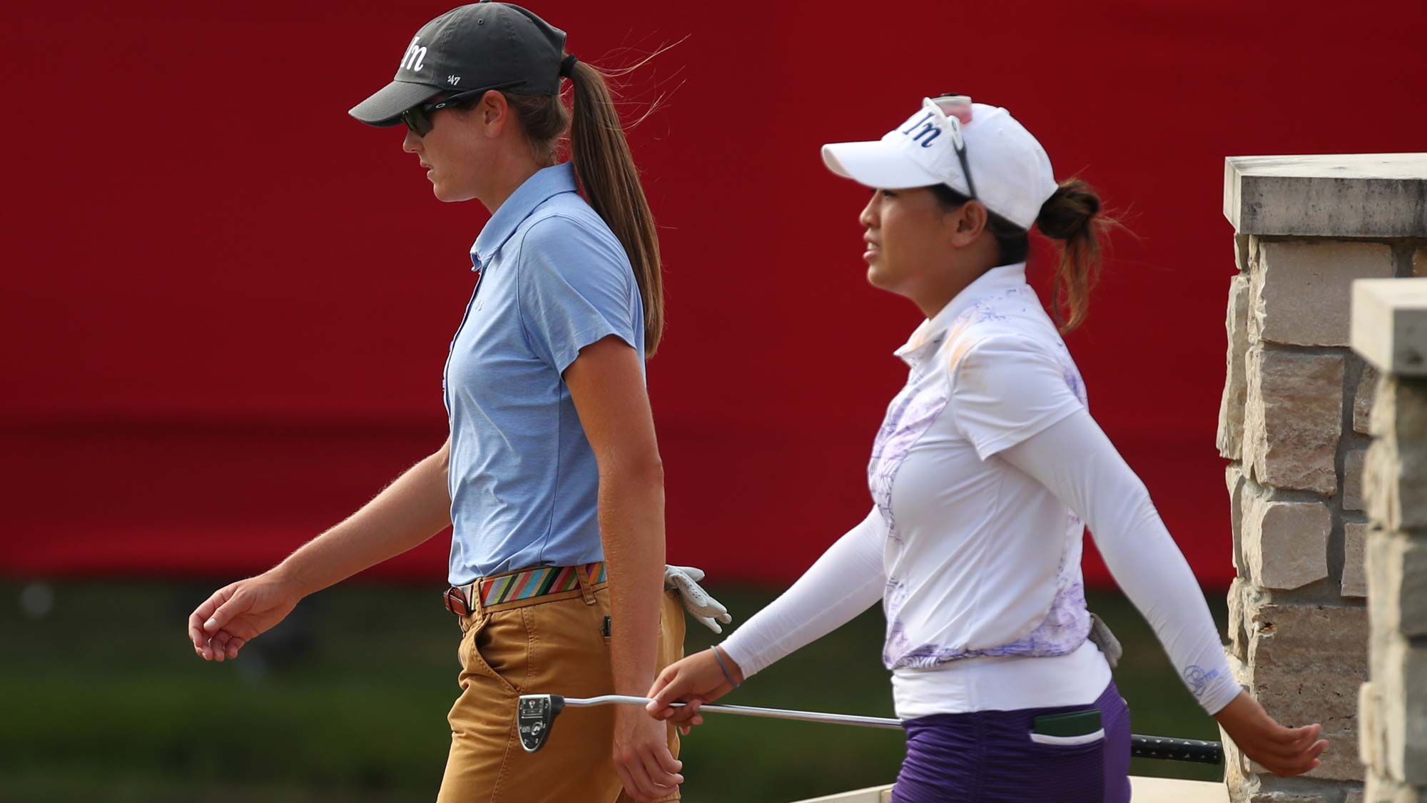 Teammates Jasmine Suwannapura of Thailand (R) and Cydney Clanton of the United States walk to the 18th green during round three of the Dow Great Lakes Bay Invitational