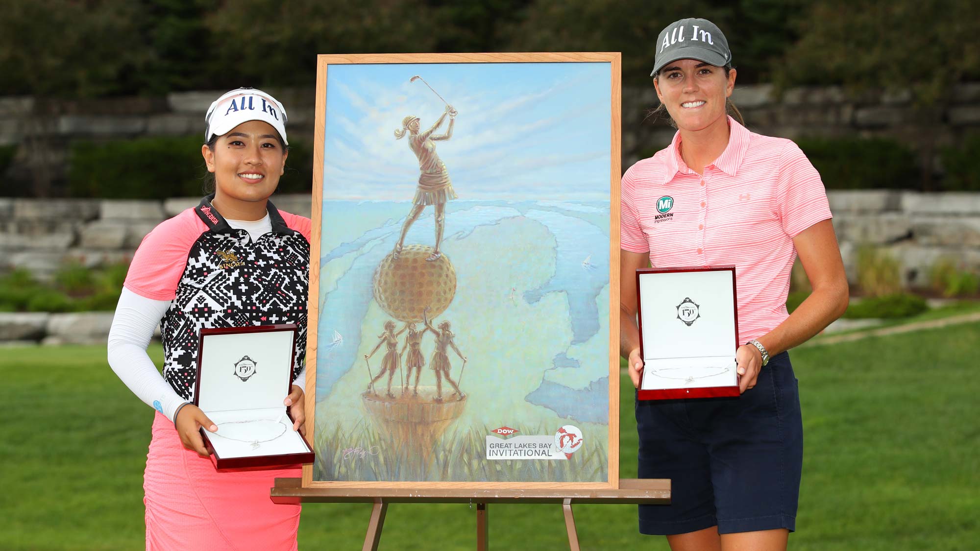 Teammates Cydney Clanton of the United States (R) and Jasmine Suwannapura of Thailand pose with the championship trophy and necklace after winning the Dow Great Lakes Bay Invitational