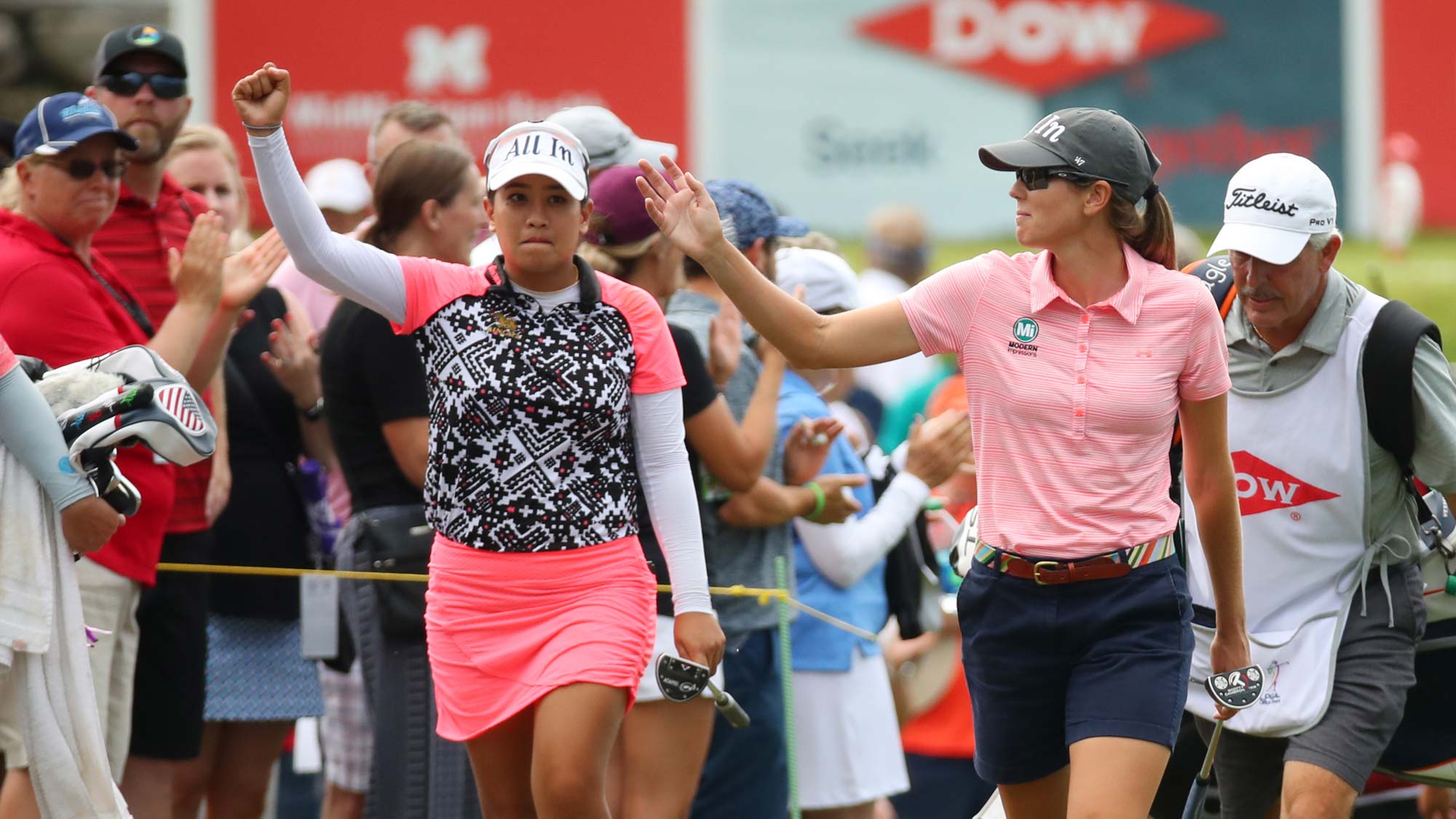 Teammates Cydney Clanton of the United States (R) and Jasmine Suwannapura of Thailand walk to the 18th green during the final round of the Dow Great Lakes Bay Invitational 