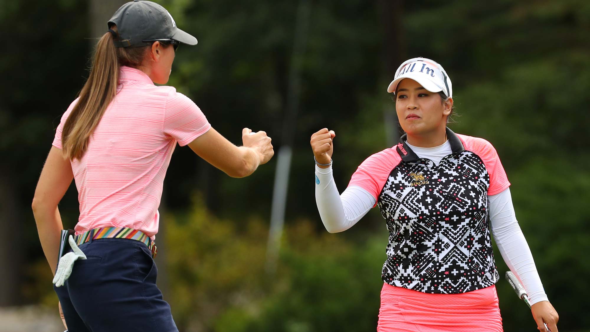 Teammates Jasmine Suwannapura of Thailand and Cydney Clanton of the United States celebrate a birdie on the sixth green during the final round of the Dow Great Lakes Bay Invitational