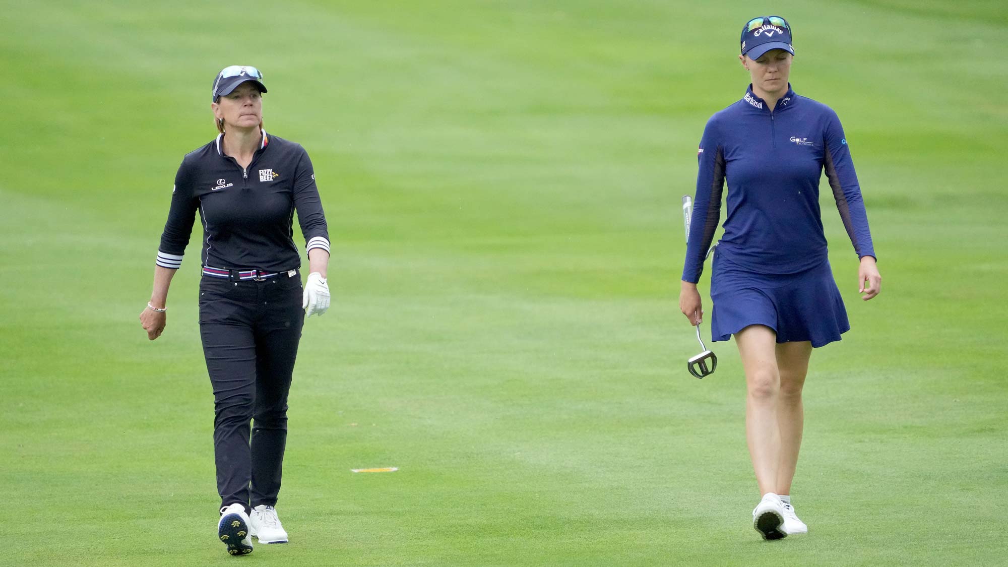 Annika Sorenstam of Sweden (L) and Madelene Sagstrom of Sweden walk across the eighth hole during the first round of the Dow Great Lakes Bay Invitational