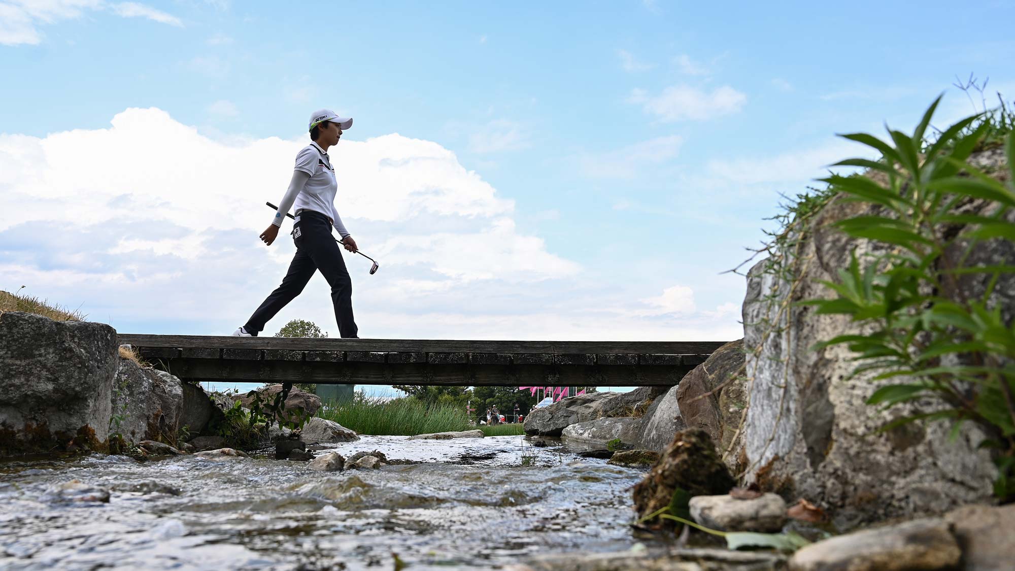 Hyo Joo Kim of Korea walks over a bridge during day 3 of the Evian Championship