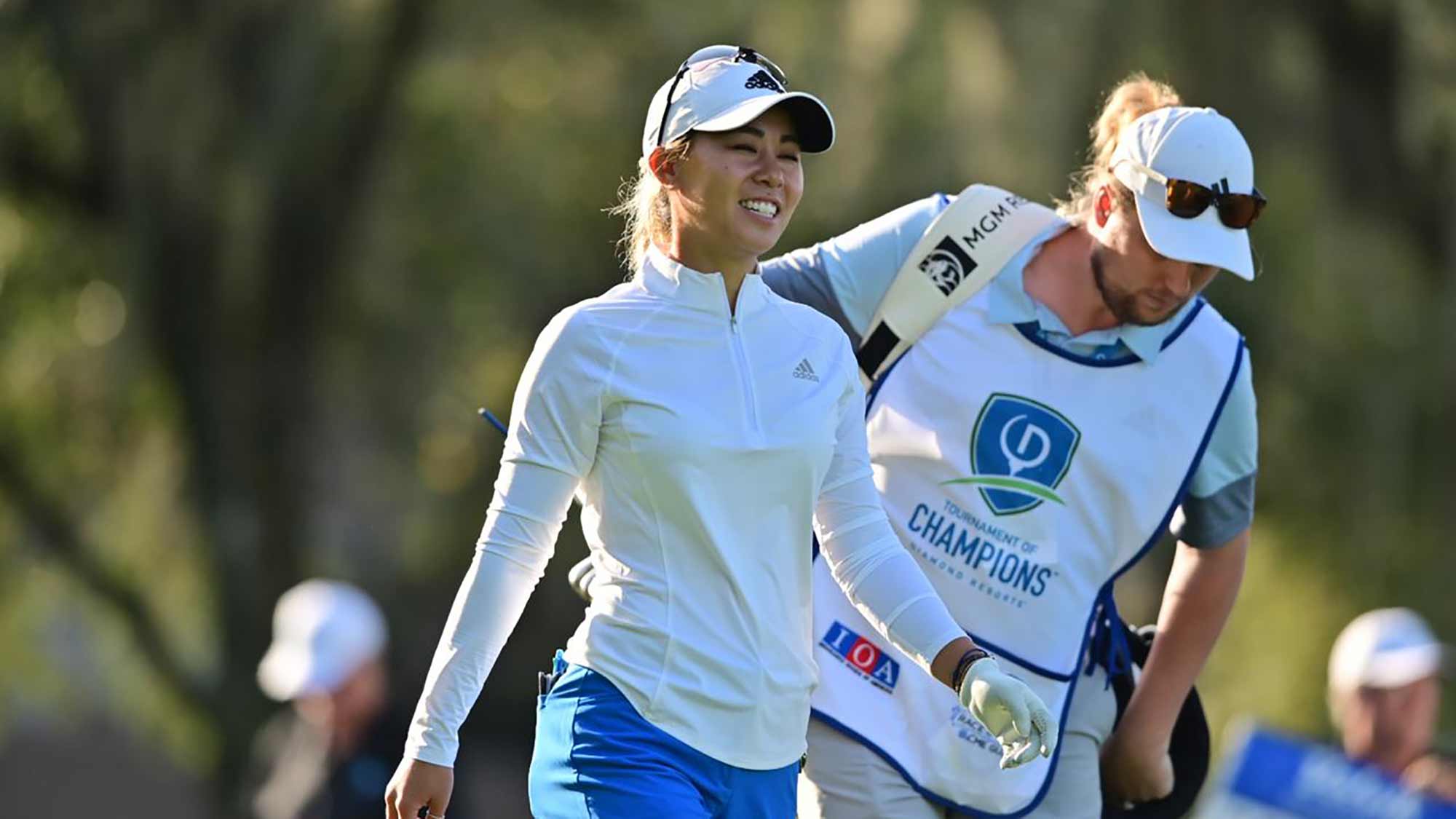 Danielle Kang smiles while walking with her caddie during the opening round of the Diamond Resorts Tournament of Champions presented by Insurance Office of America on January 16, 2020