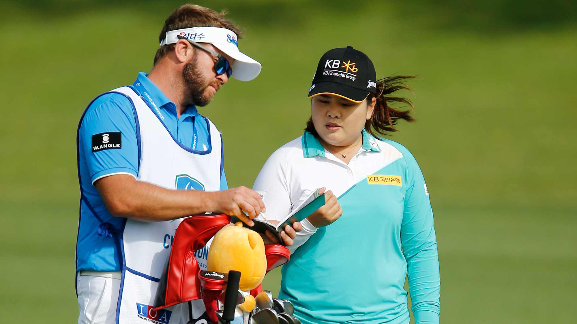 Inbee Park of South Korea talks with her caddie before playing her second shot on the 17th hole during the second round of the Diamond Resorts Tournament of Champions at Tranquilo Golf Course at Four Seasons Golf and Sports Club Orlando on January 17, 2020 in Lake Buena Vista, Florida