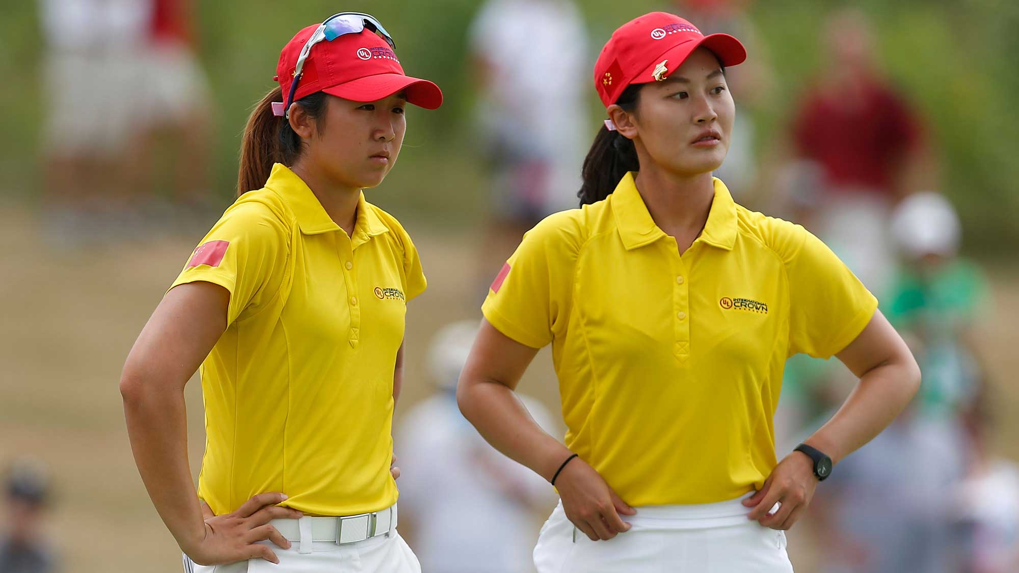 (L) Jing Yan and (R) Xi Yu Lin of China wait on the third green during the four-ball session of the 2016 UL International Crown