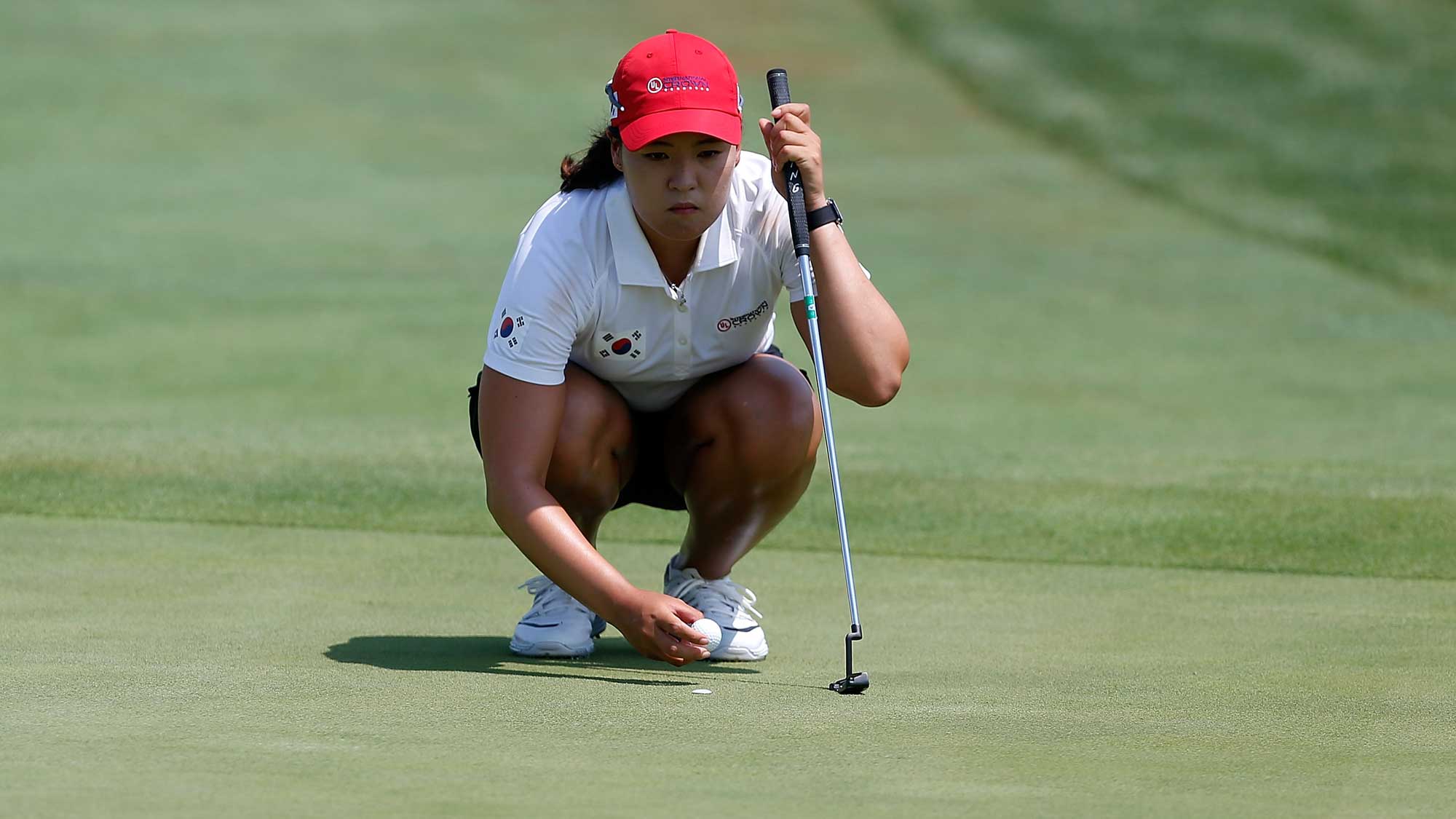 In Gee Chun of Korea lines up a putt on the first hole during the singles m...