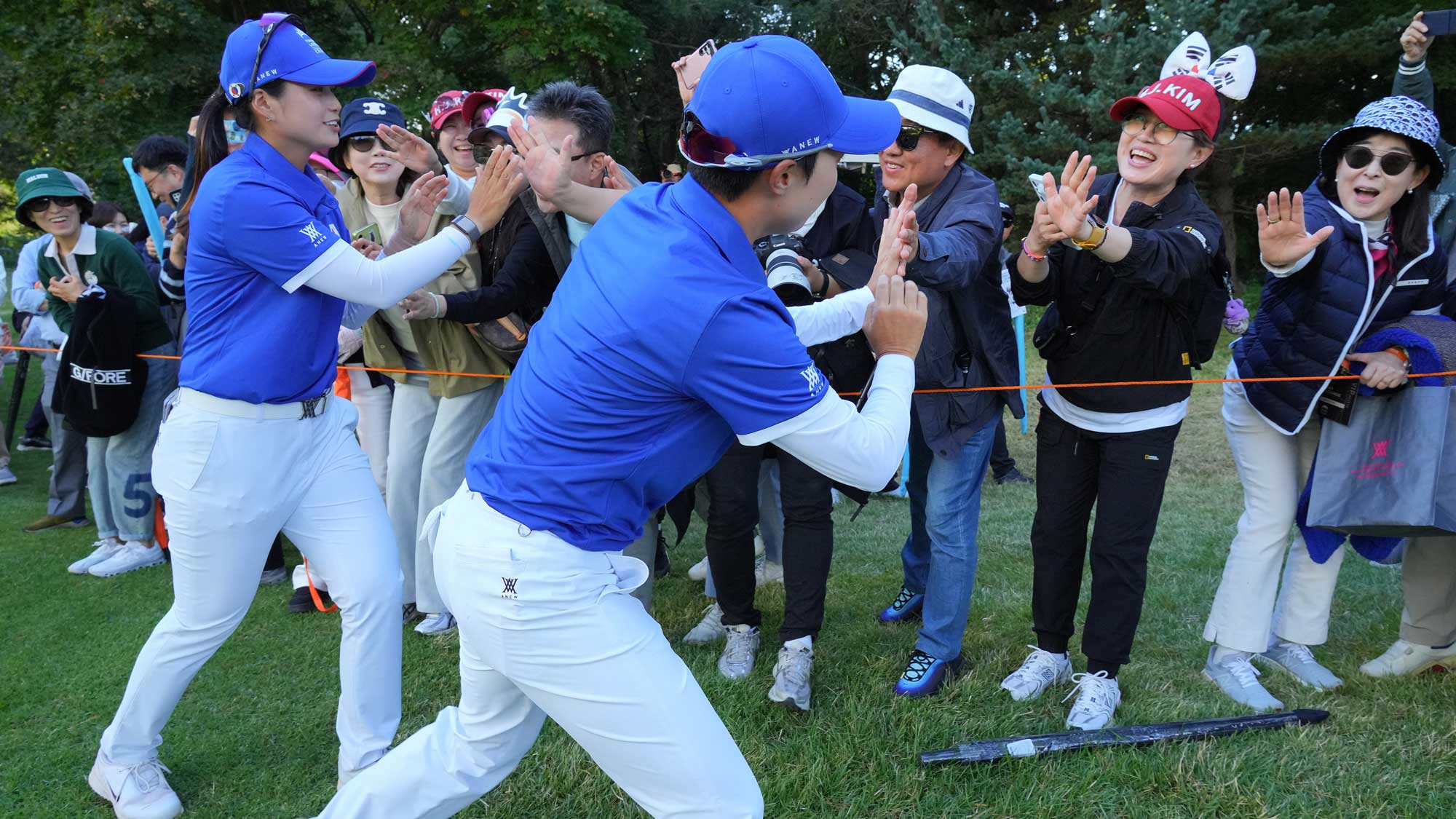 Hyo Joo Kim and Hye-Jin Choi of Republic of Korea Team high five with gallery