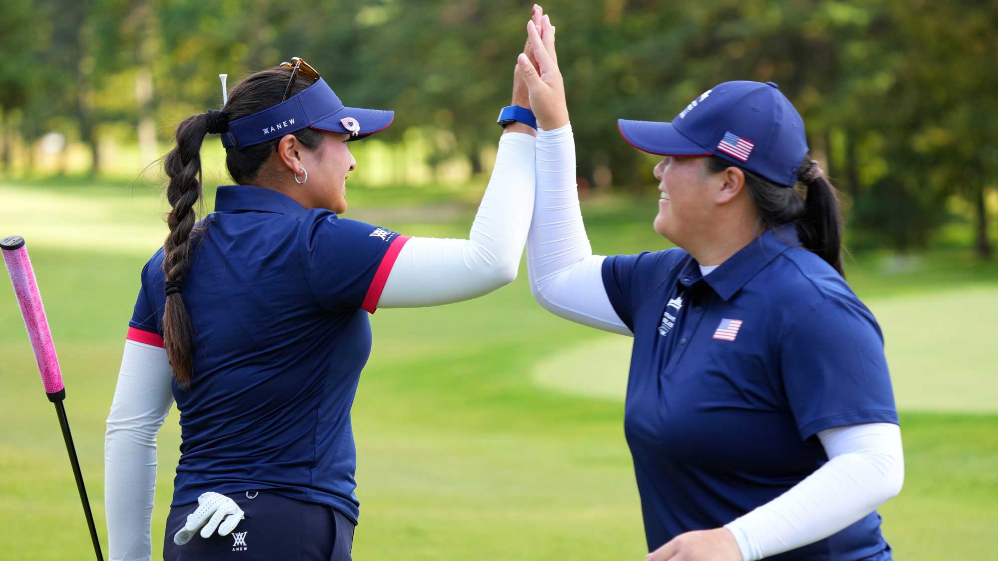 Lilia Vu (L) of the United States Team high fives with Angel Yin (R)