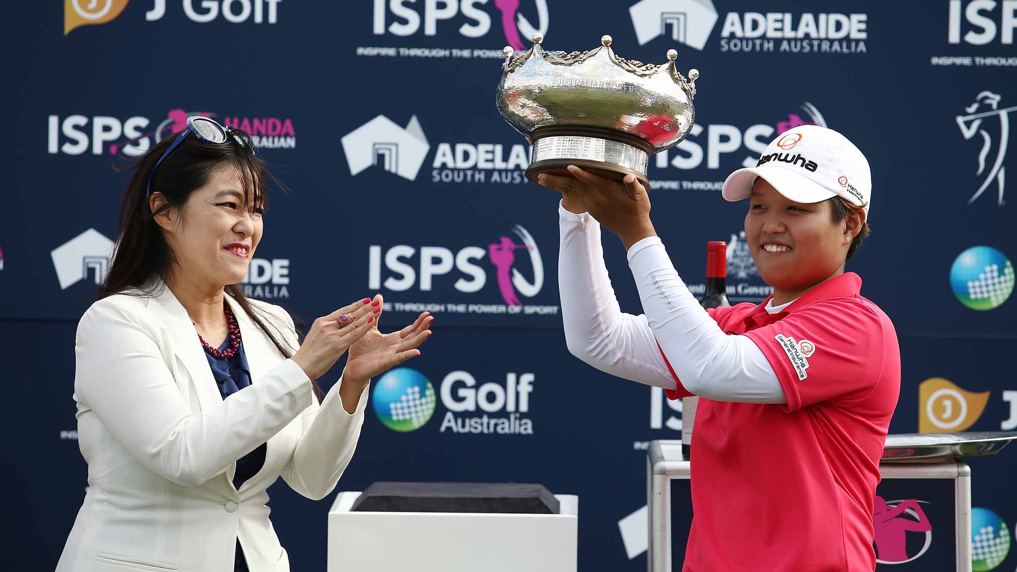 aru Nomura of Japan is presented with the winners trophy by Midori Miyazaki after winning the Women's Australian Open