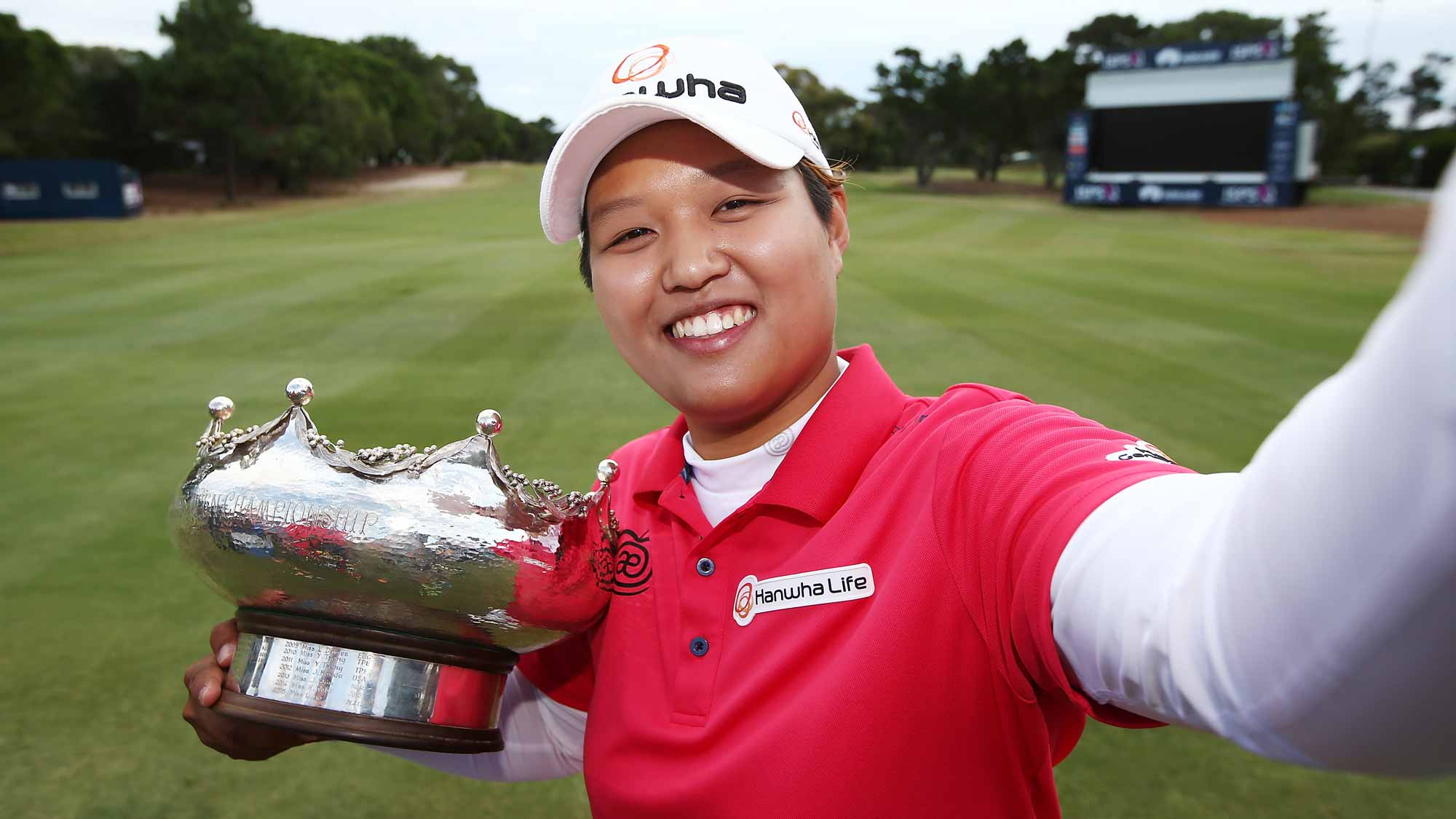 Haru Nomura of Japan pretends to take a selfie with the trophy after she won the Women's Australian Open on day four of the ISPS Handa Women's Australian Open
