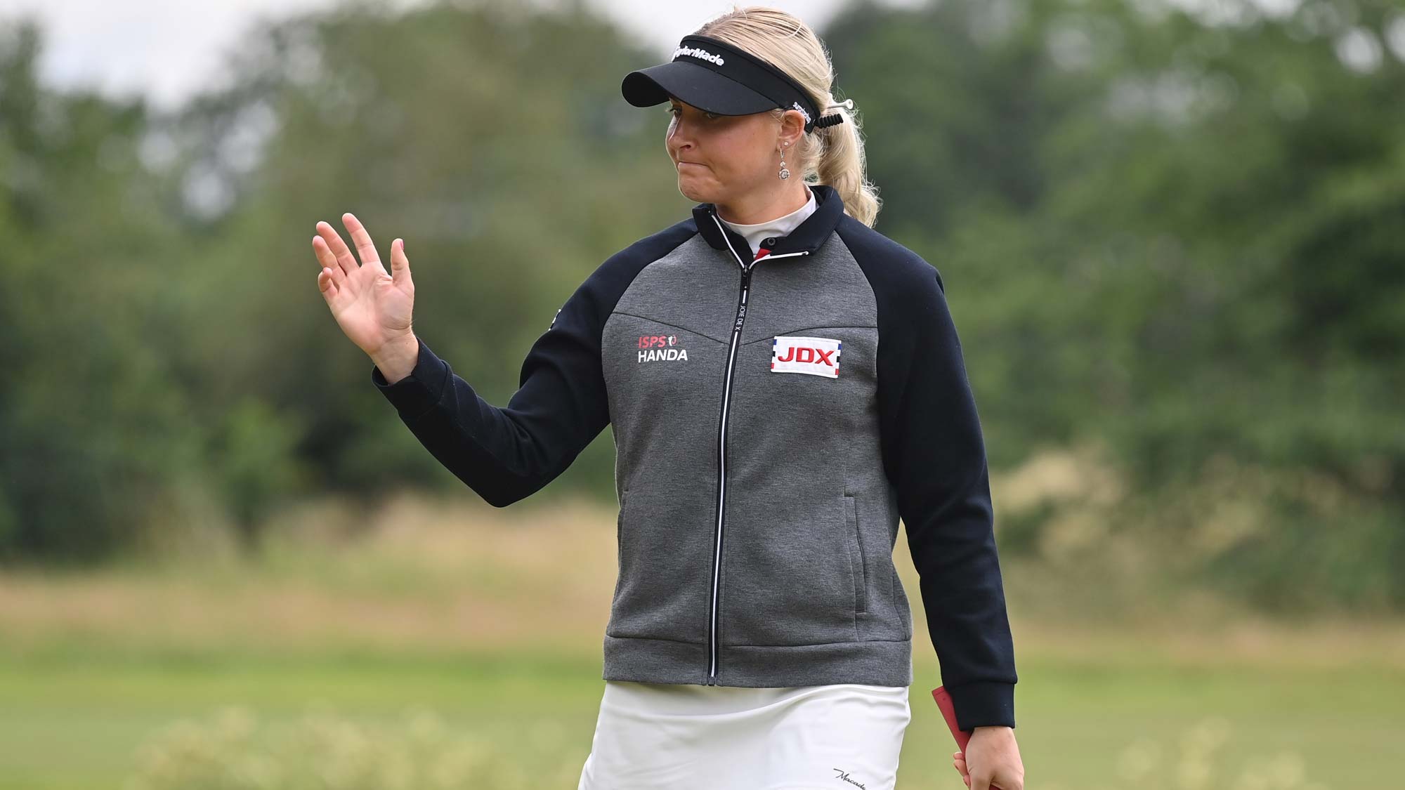Charley Hull of England acknowledges the crowd during the first round of The ISPS HANDA World Invitational