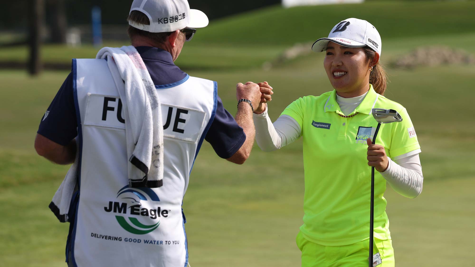 Ayaka Furue of Japan celebrates with her caddie on the 18th green during the final round of the JM Eagle LA Championship presented by Plastpro