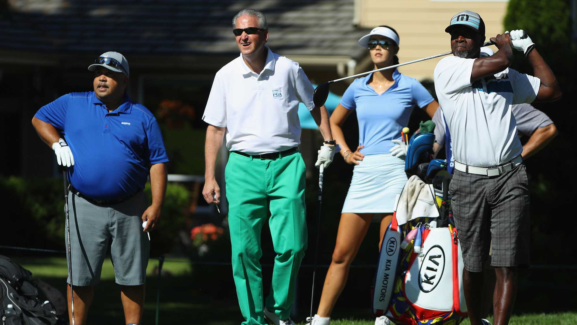 Actor Don Cheadle hits a shot as Scott Ozanus of KPMG, Michelle Wie and Michael Collins of ESPN look on during the pro-am prior to the start of the KPMG Women's PGA Championship