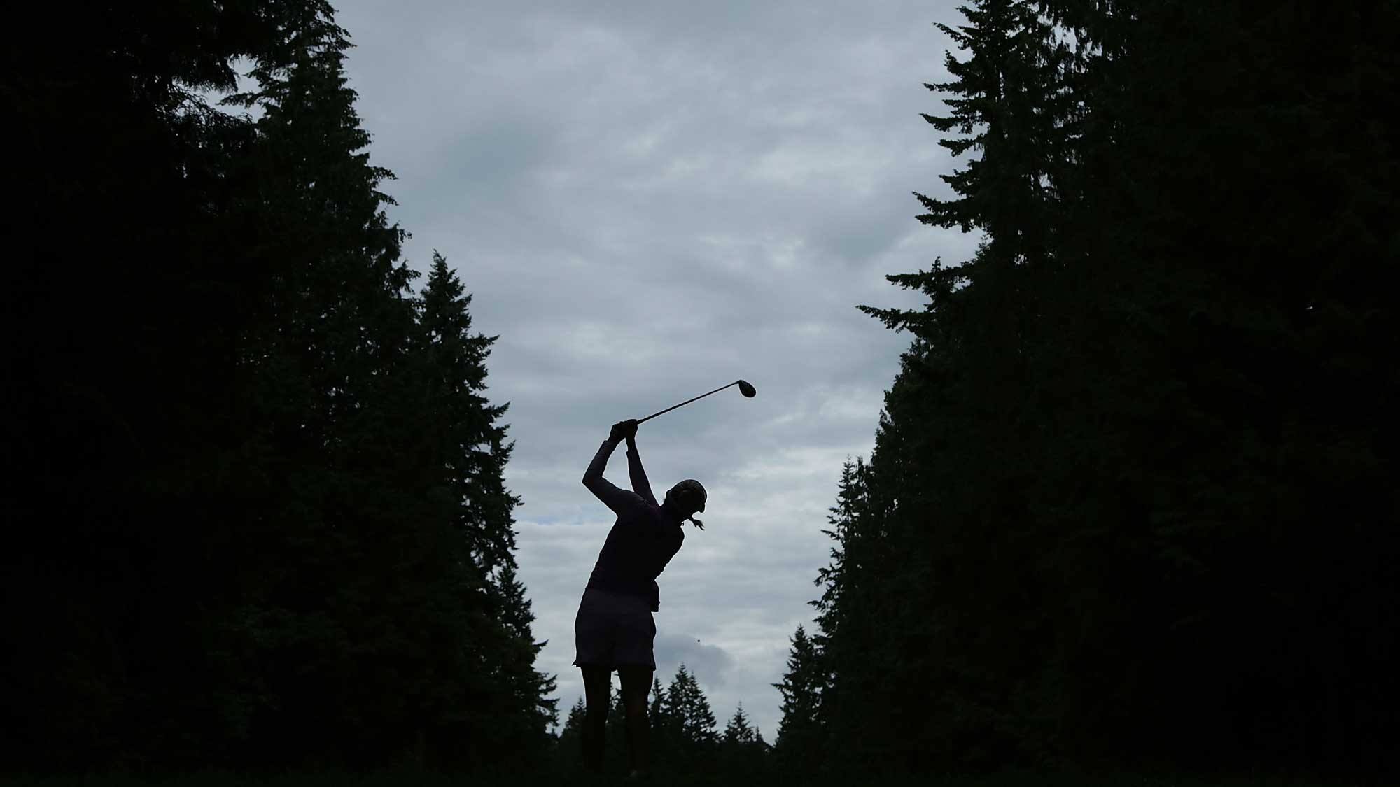 A silhouette of Lexi Thompson as she hits a tee shot on the 16th hole during the first round of the KPMG Women's PGA Championship