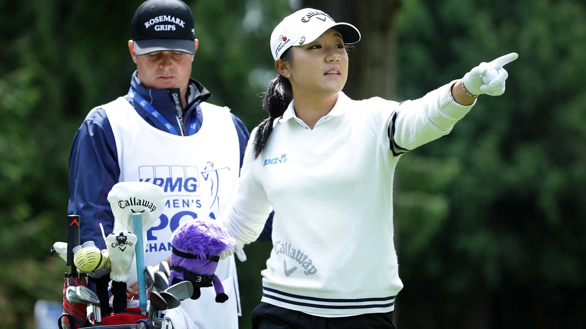 Lydia Ko of New Zealand gestures to her caddie Jason Hamilton before hitting her tee shot on the seventh hole during the third round of the KPMG Women's PGA Championship