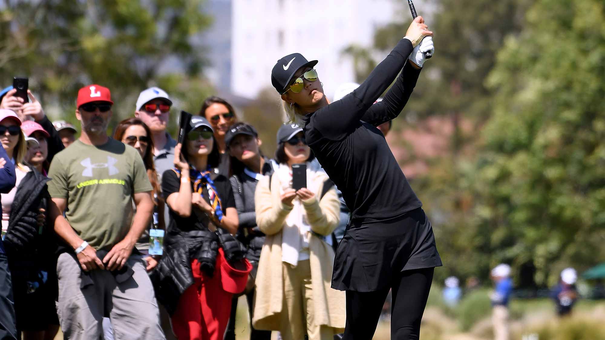 Michelle Wie hits a second shot out of the rough on the sixth fairway during round one of the Hugel-JTBC LA Open at the Wilshire Country Club on April 19, 2018 in Los Angeles, California
