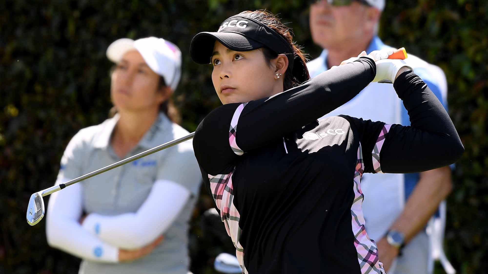 Moriya Jutanugarn of Thailand watches her tee shot in front of Marina Alex on the seventh hole during round three of the Hugel-JTBC LA Open at the Wilshire Country Club on April 21, 2018 in Los Angeles, California