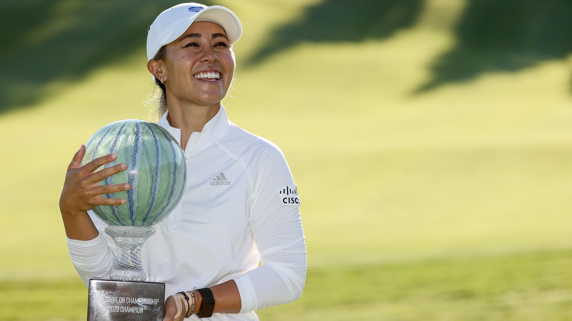 Danielle Kang celebrates with the trophy on the 18th green after her -7 under par final round victory in the LPGA Drive On Championship