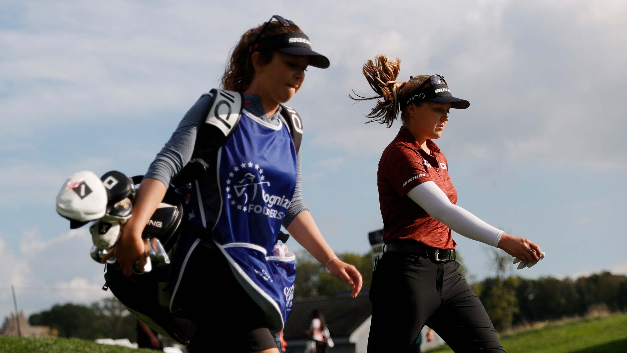Brooke M. Henderson of Canada walks with her caddie after hitting her tee shot on the 6th hole during the first round of the Cognizant Founders