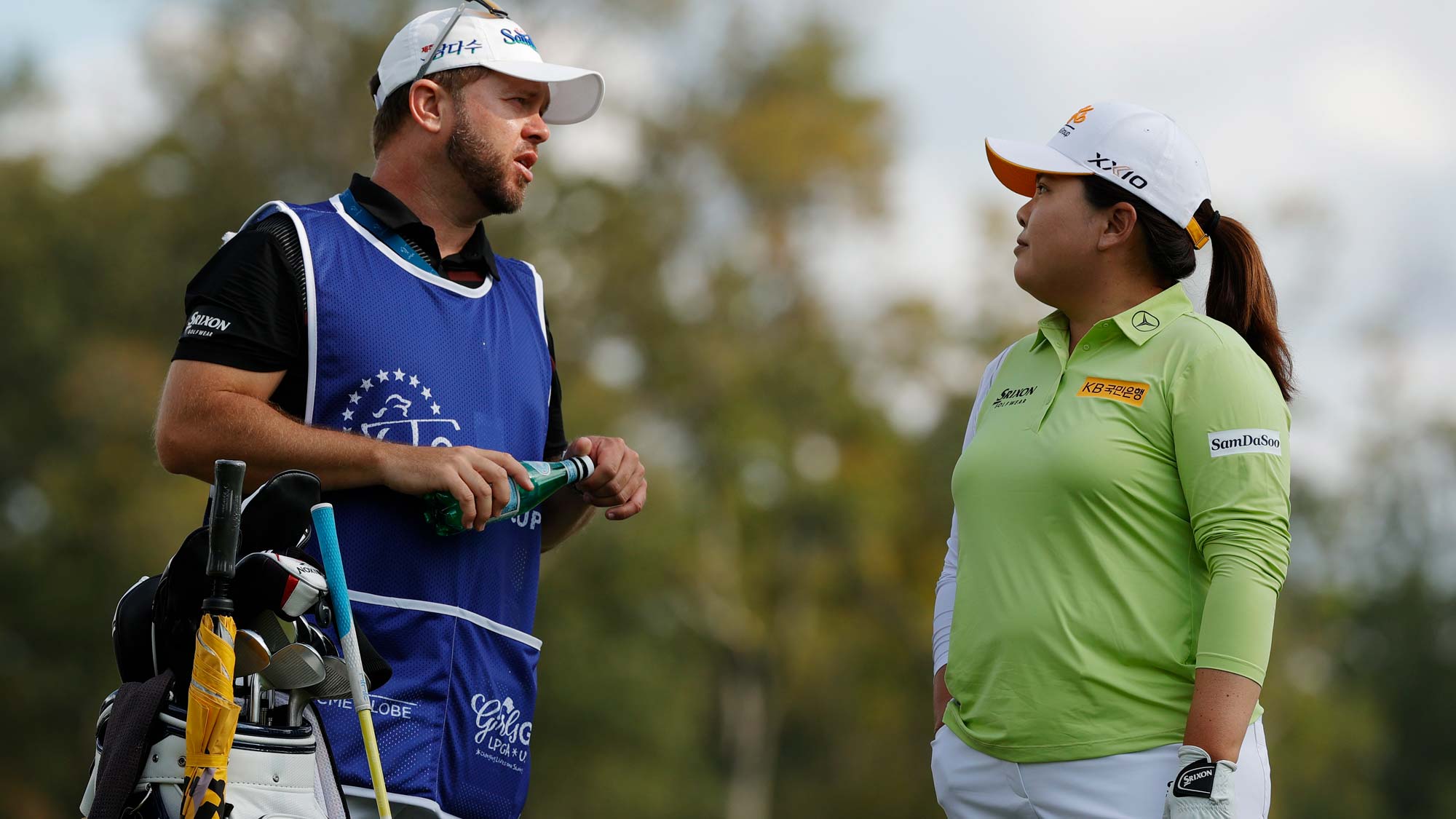 Inbee Park of Korea talks with her caddie before hitting her tee shot on the 6th hole during the first round of the Cognizant Founders Cup