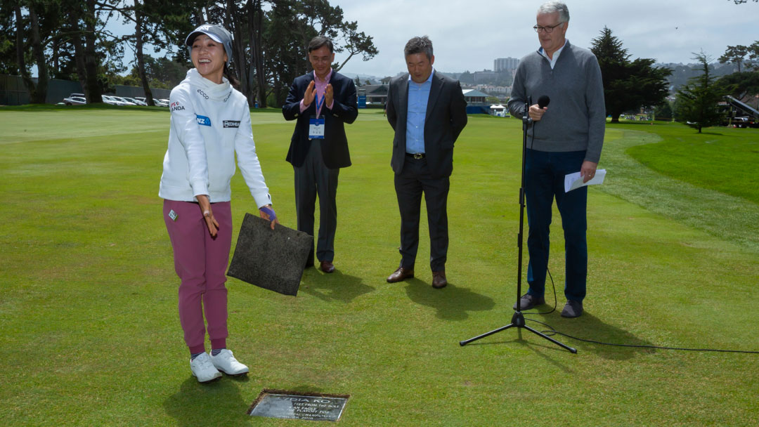 Lydia Ko poses in front of her plaque commemorating her 2nd shot on the par 5 18th hole that set up an easy eagle putt to win the 2018 LPGA MEDIHEAL Championship in a playoff.