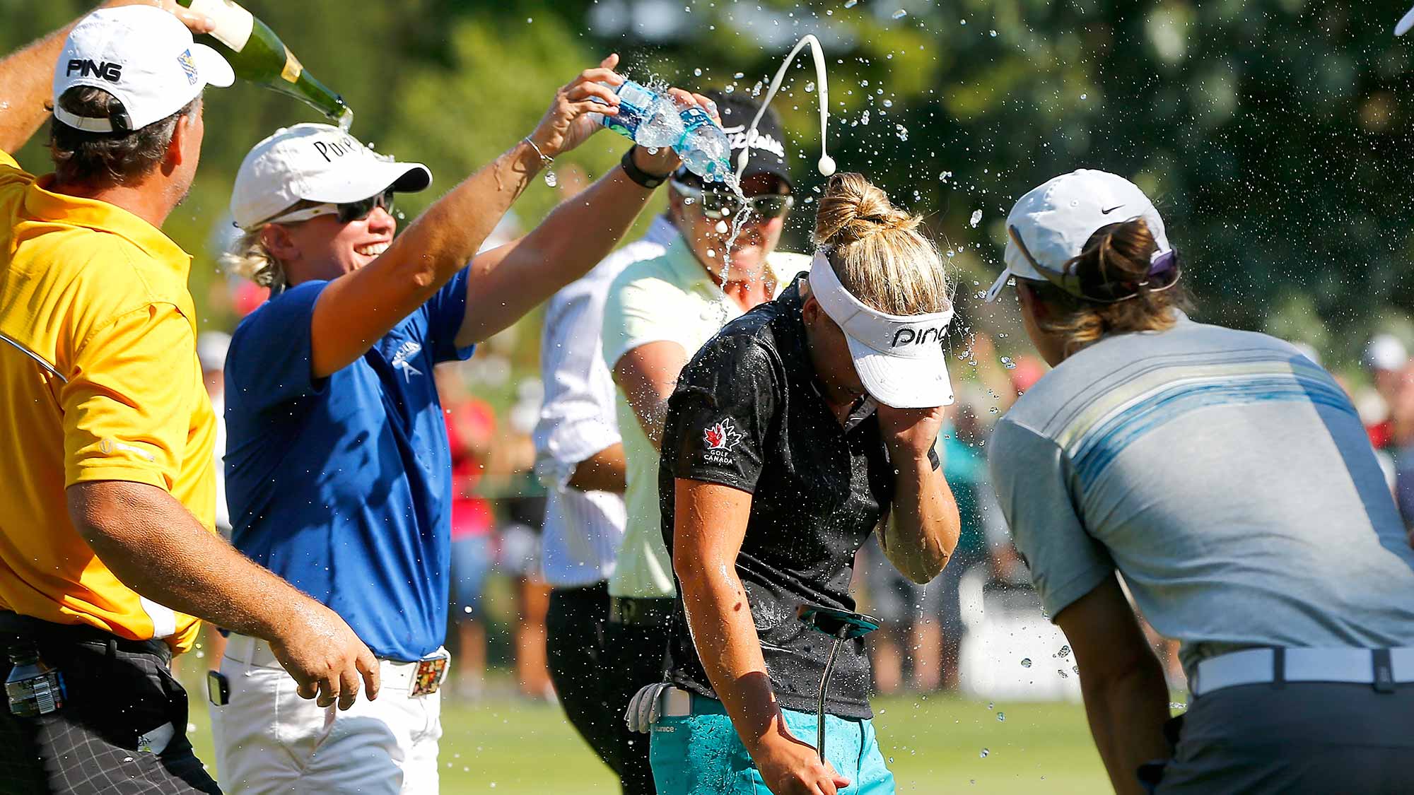 Brooke Henderson of Canada is showered with champagne on the 18th green after her 21 strokes under par victory during the final round of the LPGA Cambia Portland Classic at Columbia Edgewater Country Club