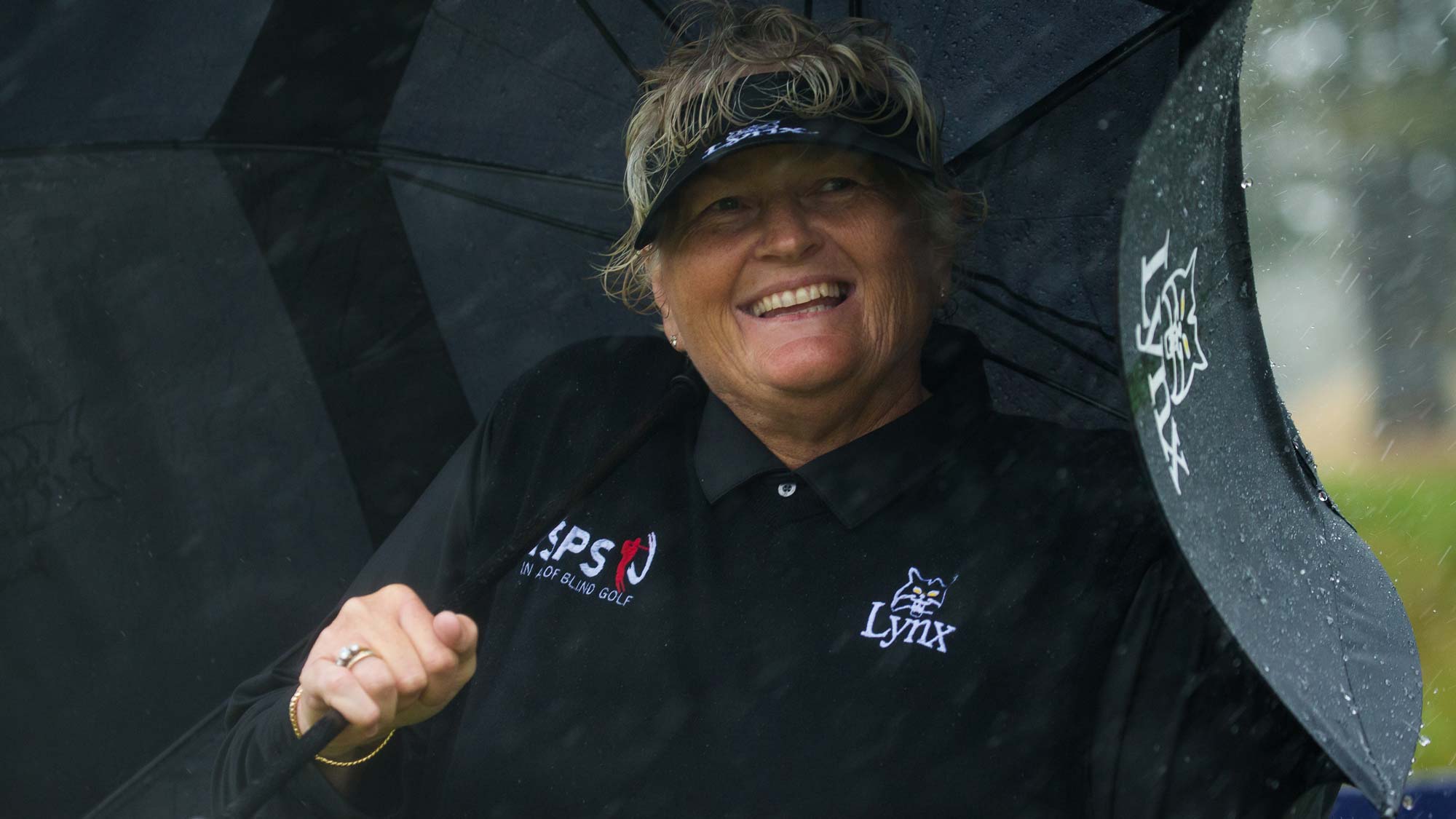Dame Laura Davies of England smiles despite the rain during the second round.