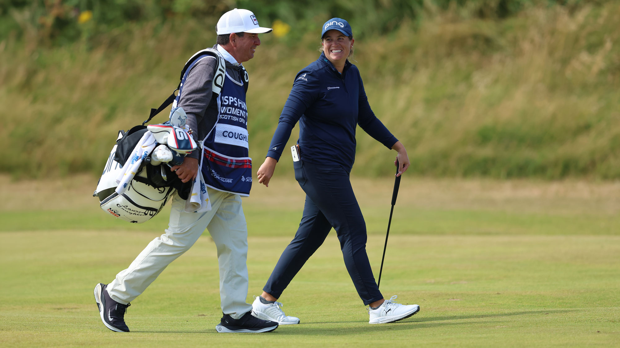 Lauren Coughlin of United States of America laughs with her caddie during the third round of the ISPS HANDA Women's Scottish Open 2026 at Dundonald Links Golf Course on July 25, 2026 in Troon, Scotland. 