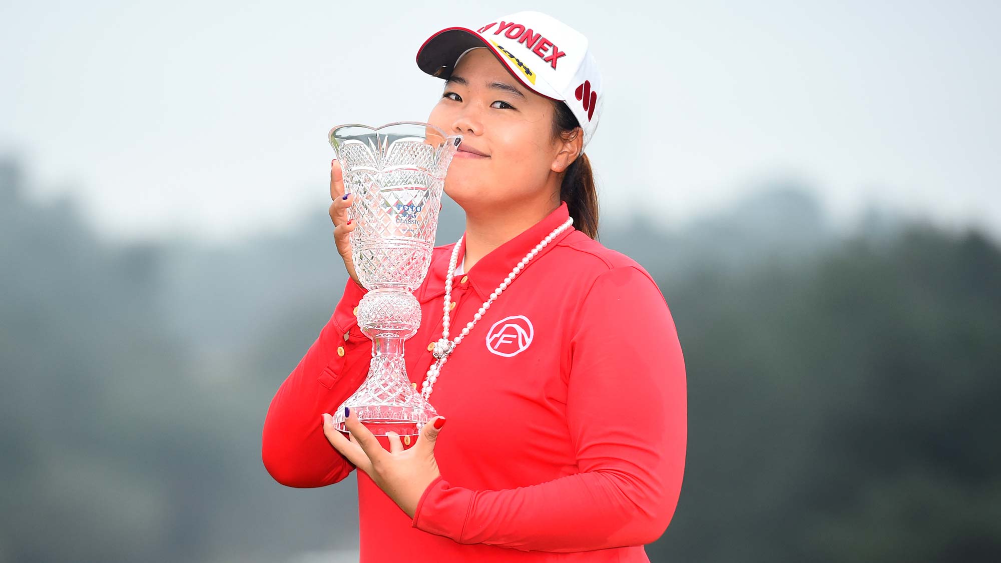 Sun-Ju Ahn of South Korea poses with the trophy after winning the TOTO Japan Classics 2015 at the Kintetsu Kashikojima Country Club