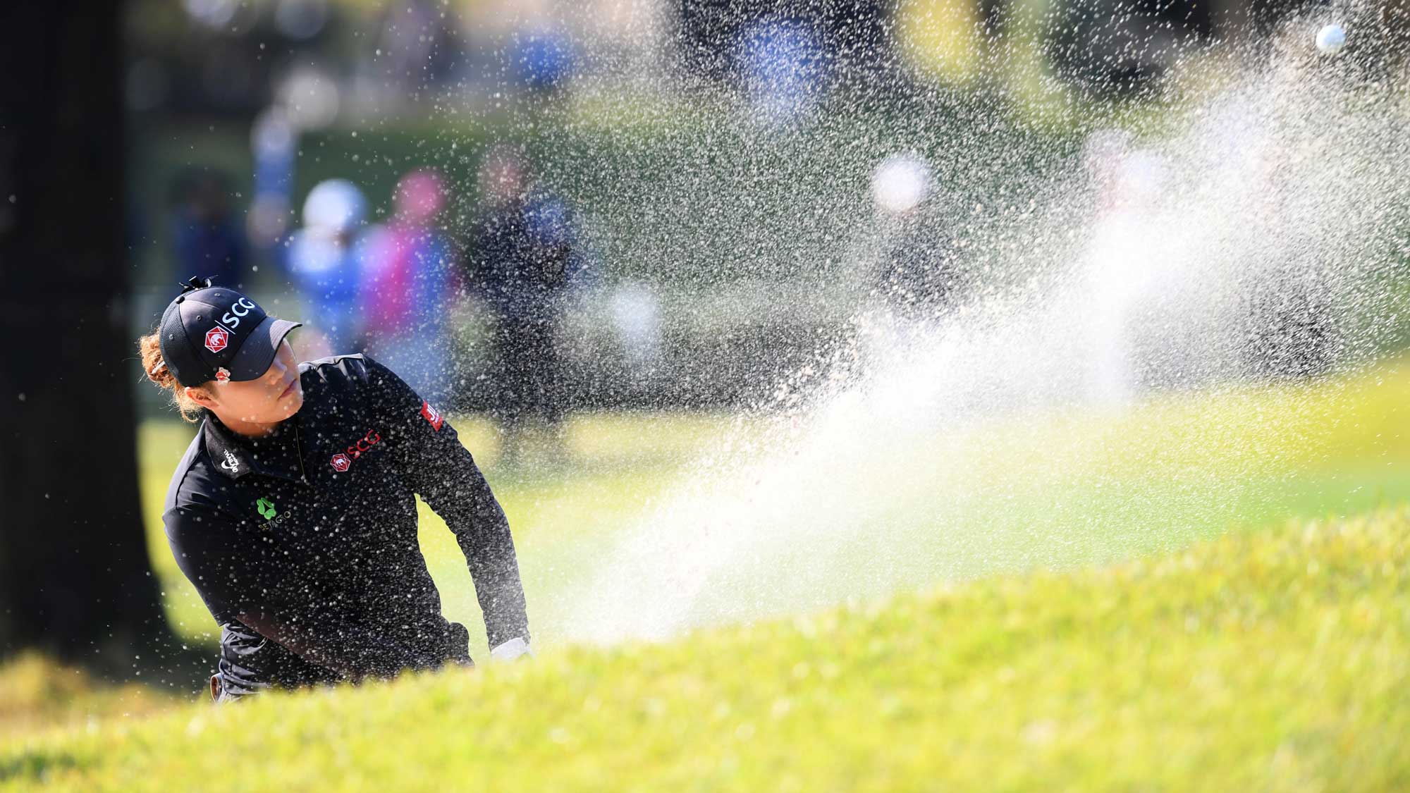 Ariya Jutanugarn of Thailand hits from a bunker on the 13th hole during the final round of the TOTO Japan Classic