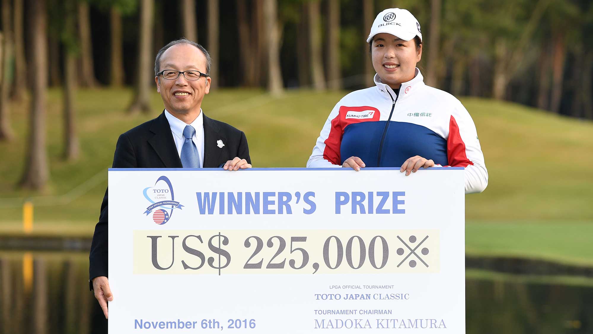 Shanshan Feng of China is presented with the winners check after winning the TOTO Japan Classic