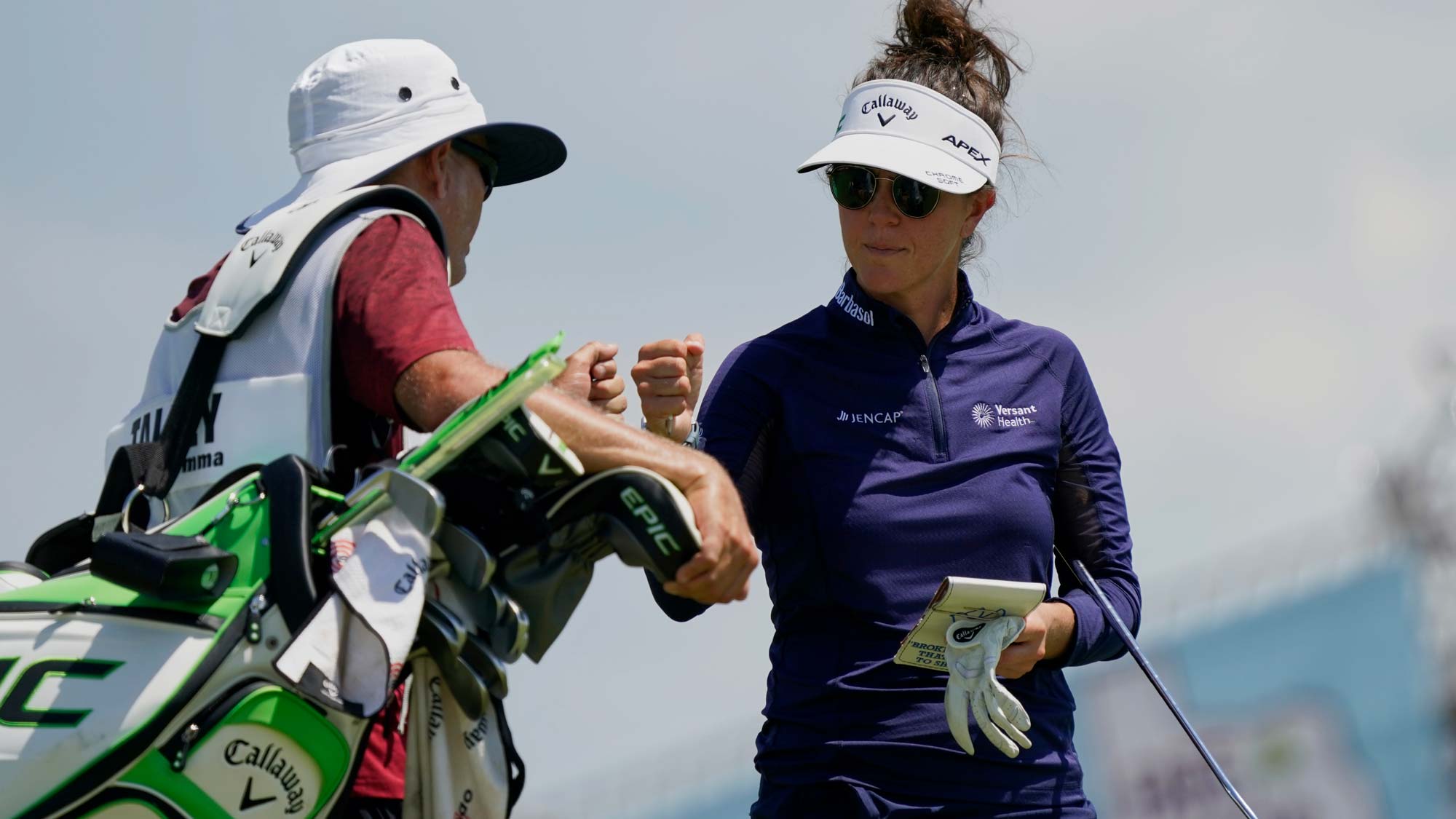 Emma Talley fist bumps her caddy after finishing her round on the 18th hole during the first round of the Volunteers of America Classic