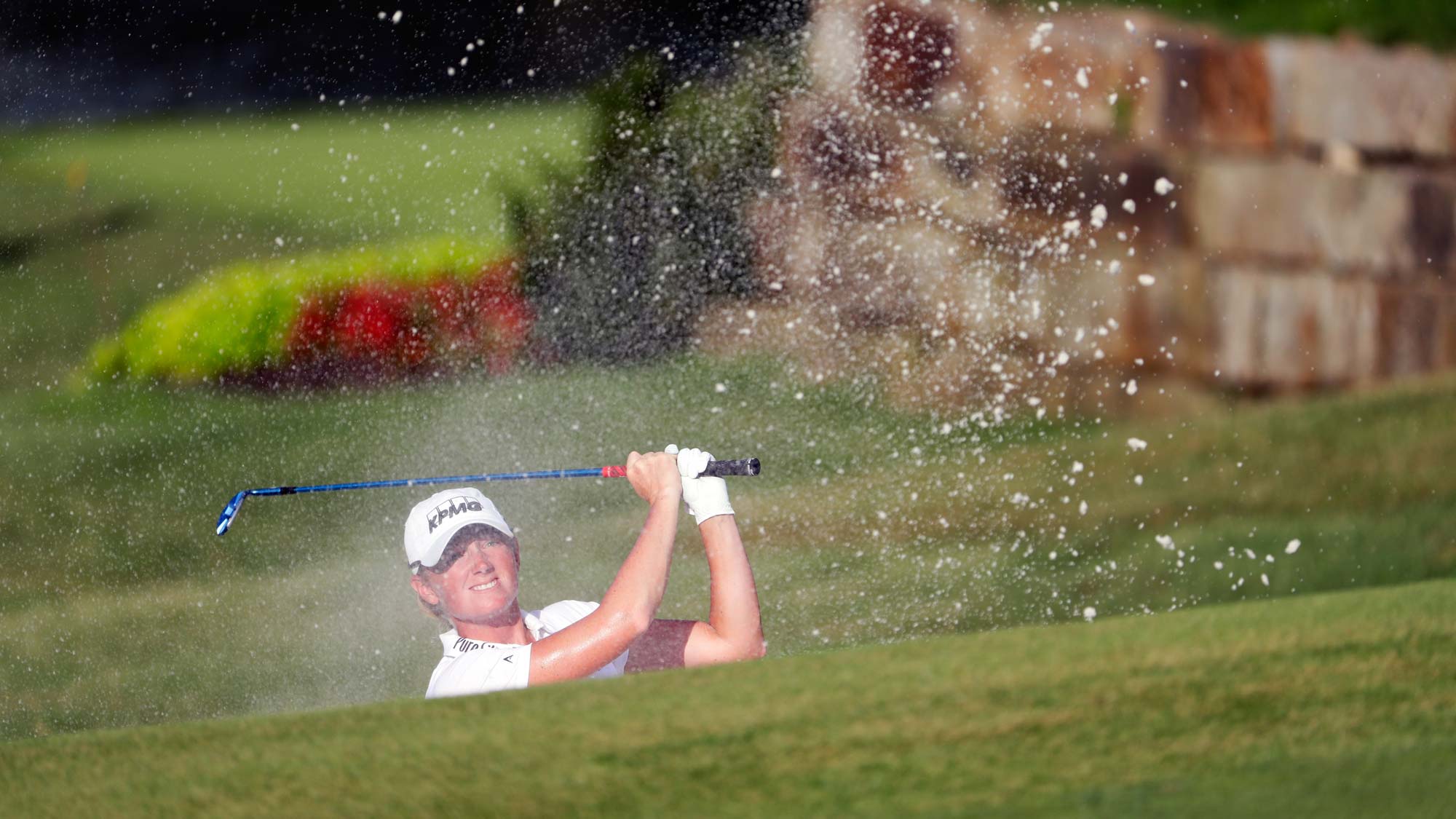Stacy Lewis of the United States hits her third shot from a bunker on the 18th hole during the second round of the Walmart NW Arkansas Championship