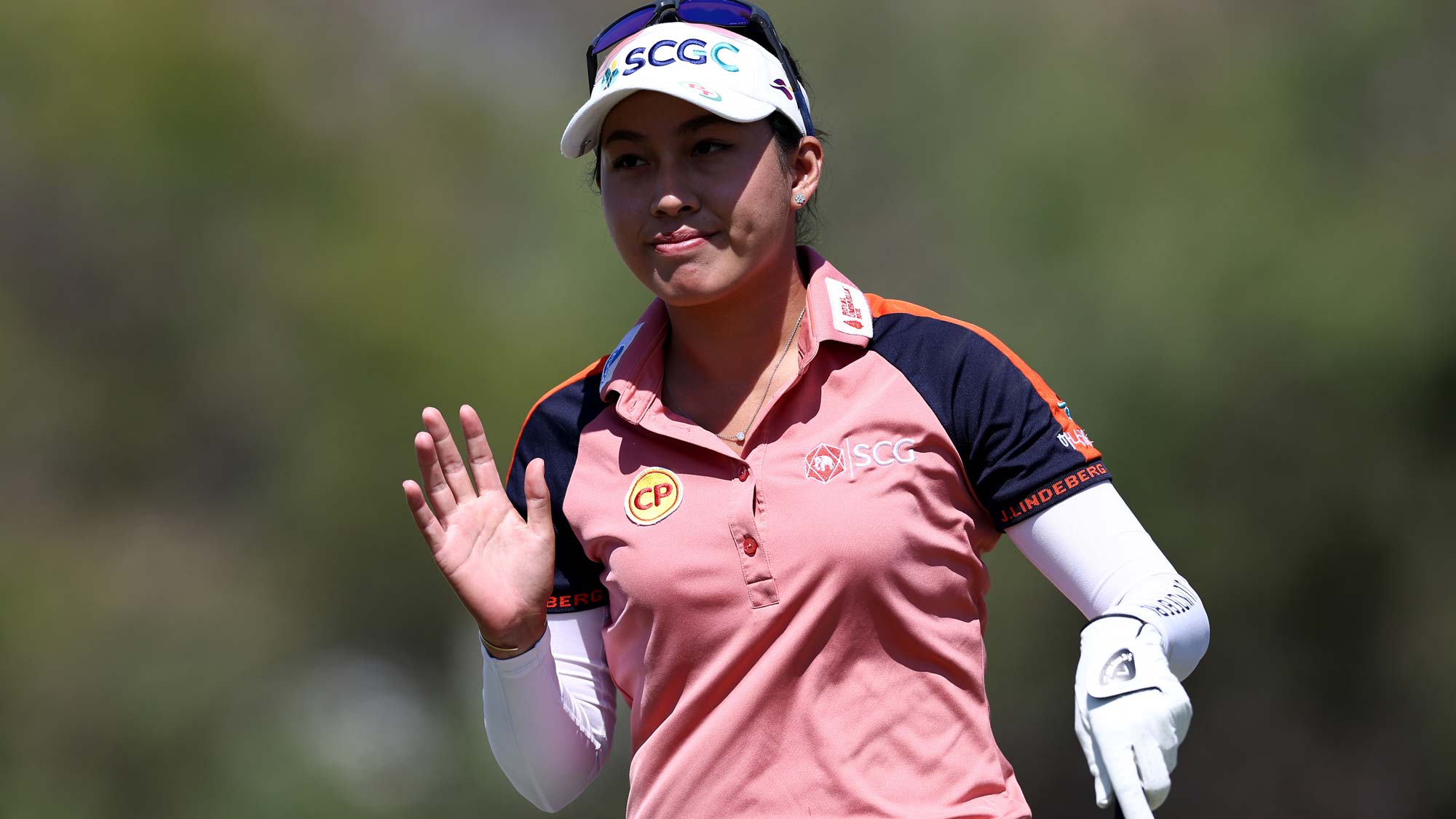 Atthaya Thitikul of Thailand waves to the gallery before playing a shot off the 10th tee during the first round of The Ascendant LPGA benefiting Volunteers of America
