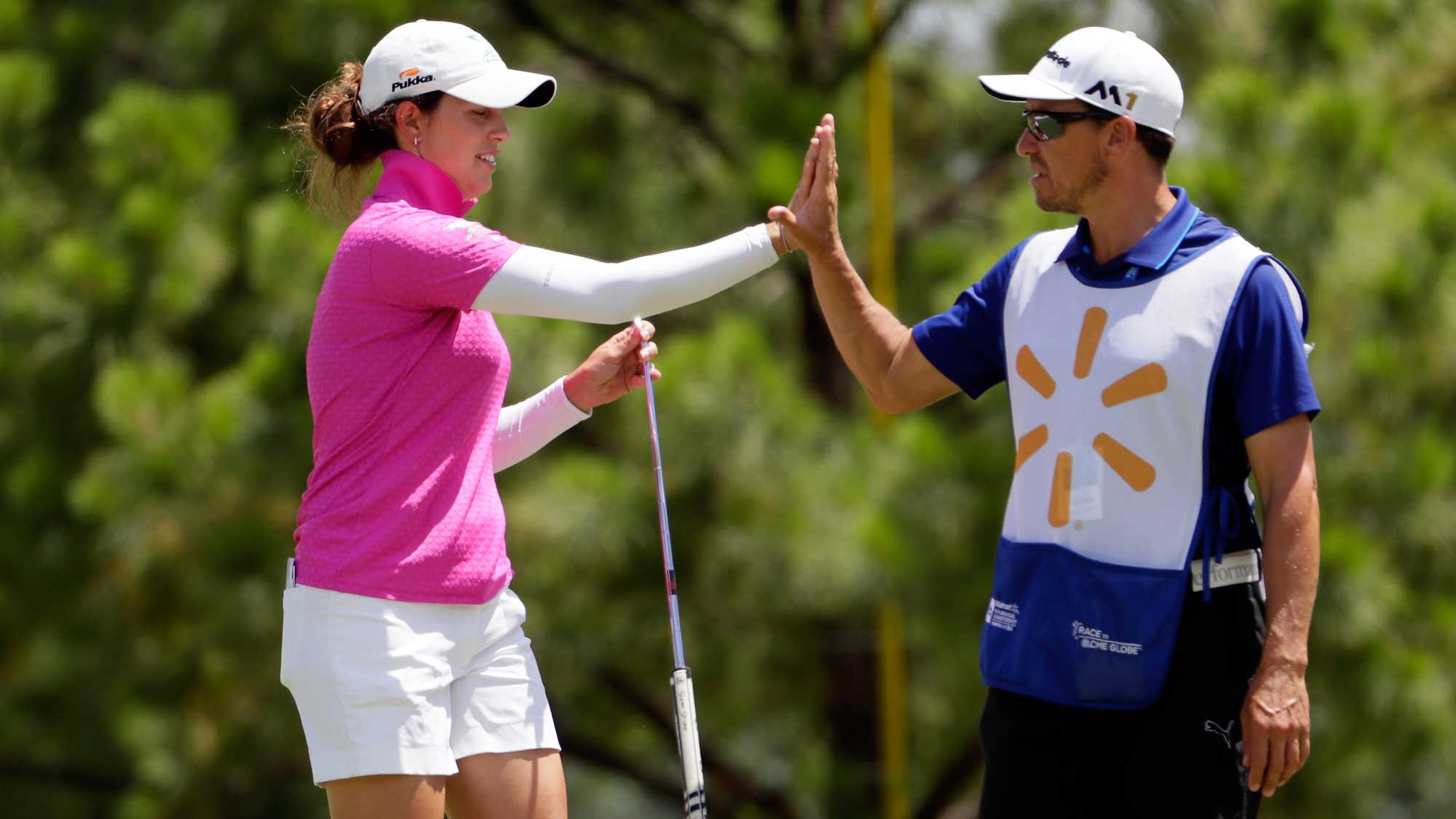 Giulia Molinaro of Italy high-fives her caddie after making a putt on the 1st hole during the final round of the Walmart NW Arkansas Championship